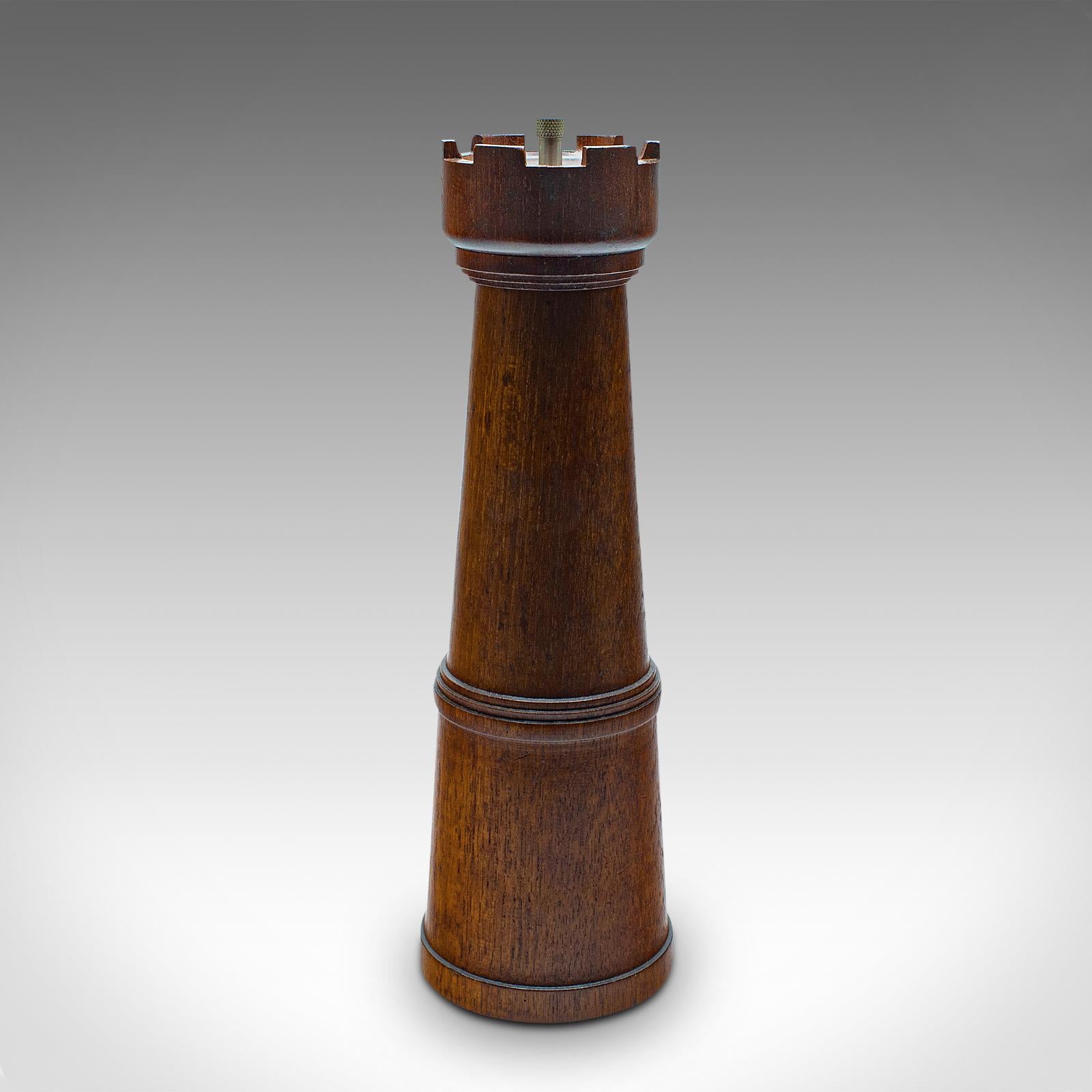 This is a vintage decorative pepper grinder. An English, oak condiment dispenser in the form of a chess rook, dating to the mid 20th century, circa 1960.

Delightfully crafted, ideal for the chess lover
Displays a desirable aged patina and in