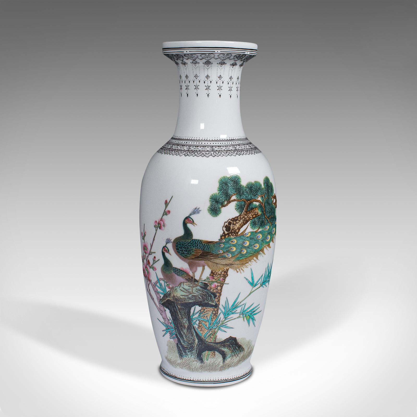 This is a vintage decorative posy vase. A Chinese, ceramic flower urn with peacock decor, dating to the mid 20th century, circa 1960. 

Pleasingly detailed vase with strong Oriental taste
Displays a desirable aged patina and in good
