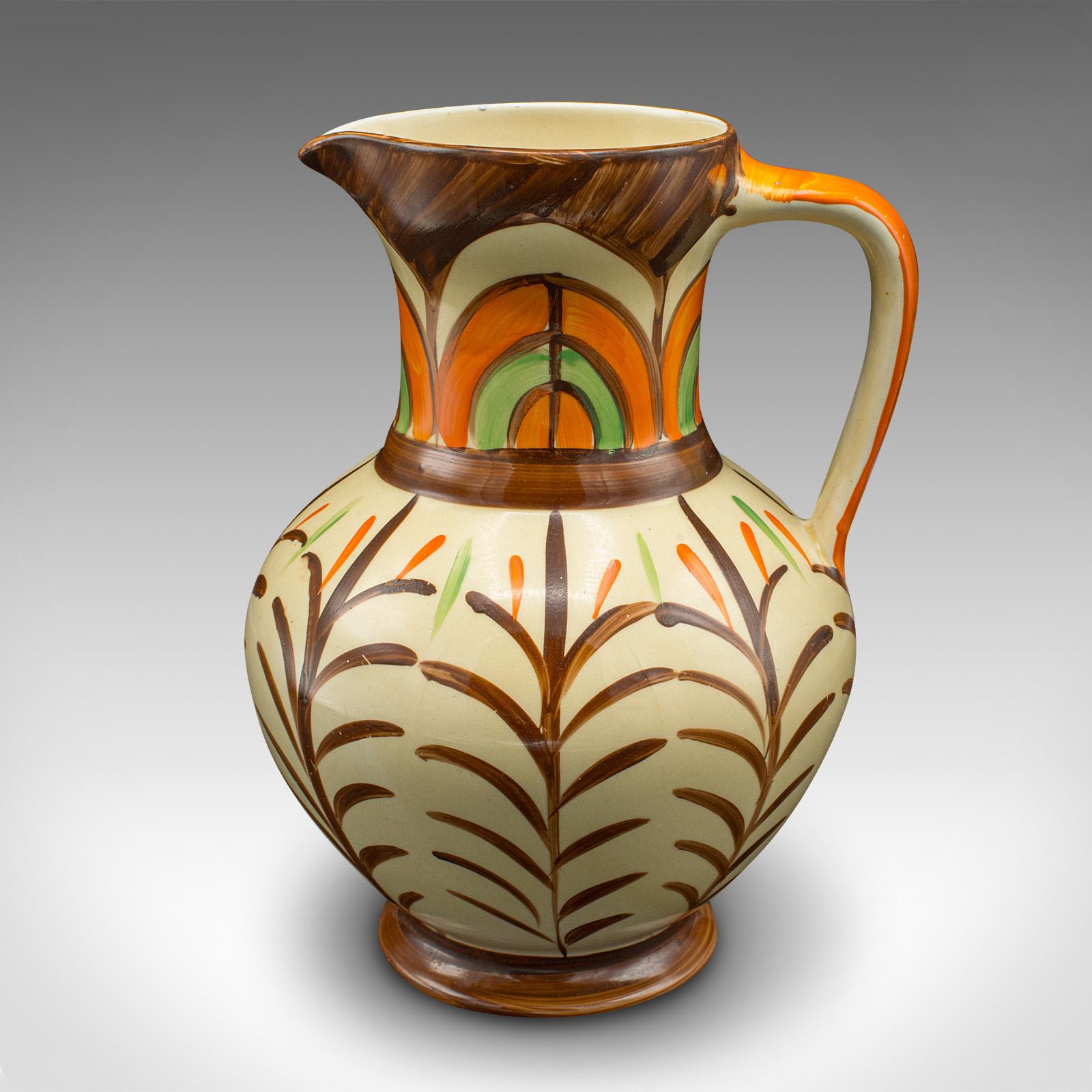 This is a vintage decorative pouring jug. An English, hand painted ceramic pourer in Art Deco taste, dating to the early 20th century, circa 1930.

Charmingly decorative jug with great hand painted colour
Displaying a desirable aged patina and in