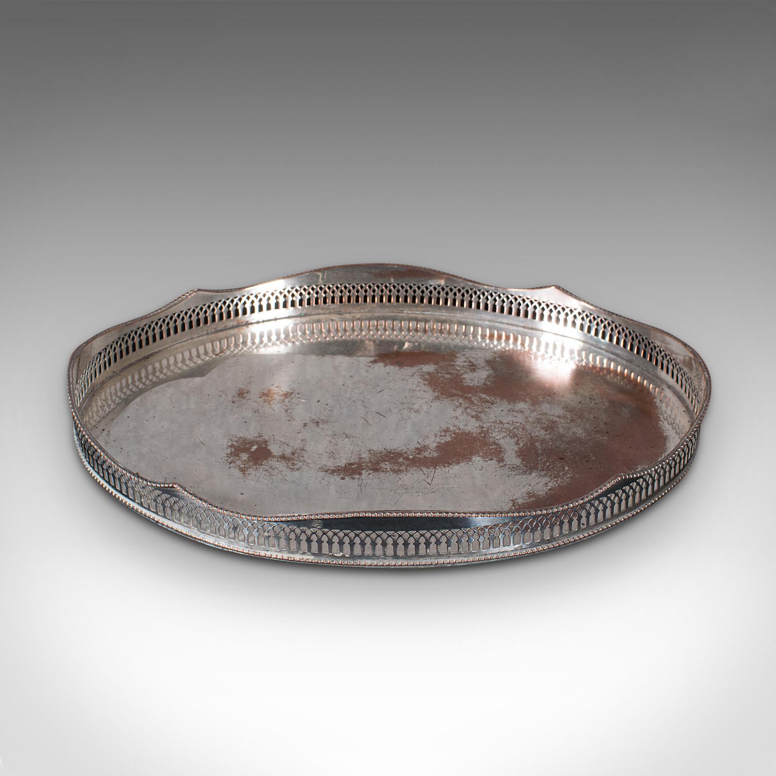 This is a vintage decorative serving tray. An English, silver plate afternoon tea oval platter, dating to the early 20th century, circa 1930.

Charming oval service tray with distinctive appearance
Displays a desirable aged patina