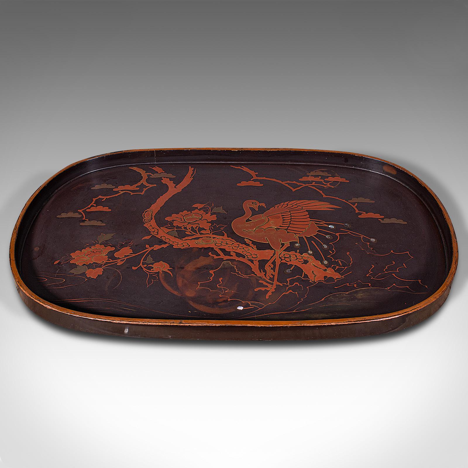 This is a vintage decorative serving tray. An Oriental, Japanned lacquer salver in Art Deco taste, dating to the mid 20th century, circa 1940.

Eye-catching serving tray with strong Oriental Art Deco taste
Displays a desirable aged patina