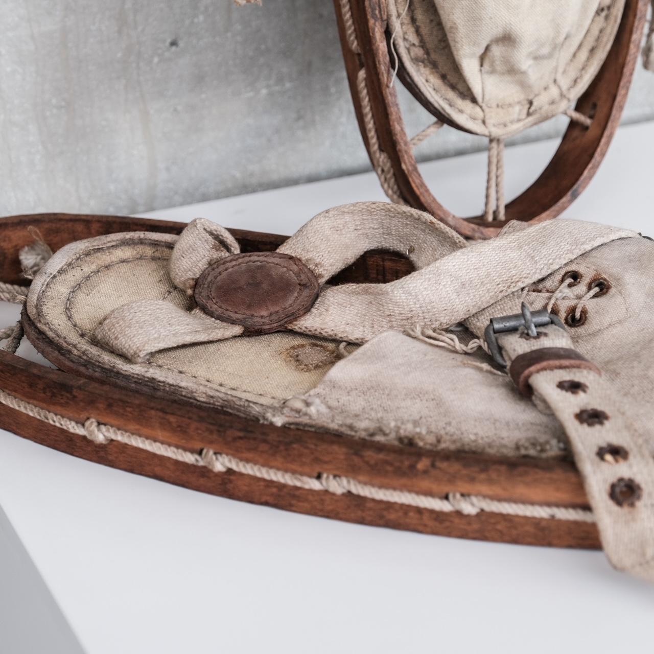 A pair of vintage unusual snow shoes, with wooden surrounds and sprung string design.

France, circa 1930s.

Good vintage condition, but for use as a prop only we would suggest.

Ideal as the final touch for a ski chalet project or