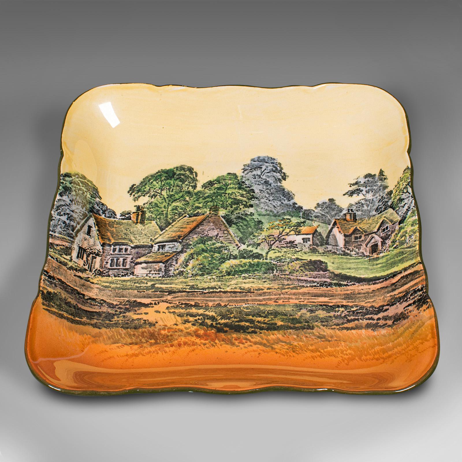 This is a vintage decorative square dish. An English, ceramic serving plate, dating to the early 20th century, circa 1930.

Decorated with traditional English country side appeal
Displaying a desirable aged patina in good original order
Painted