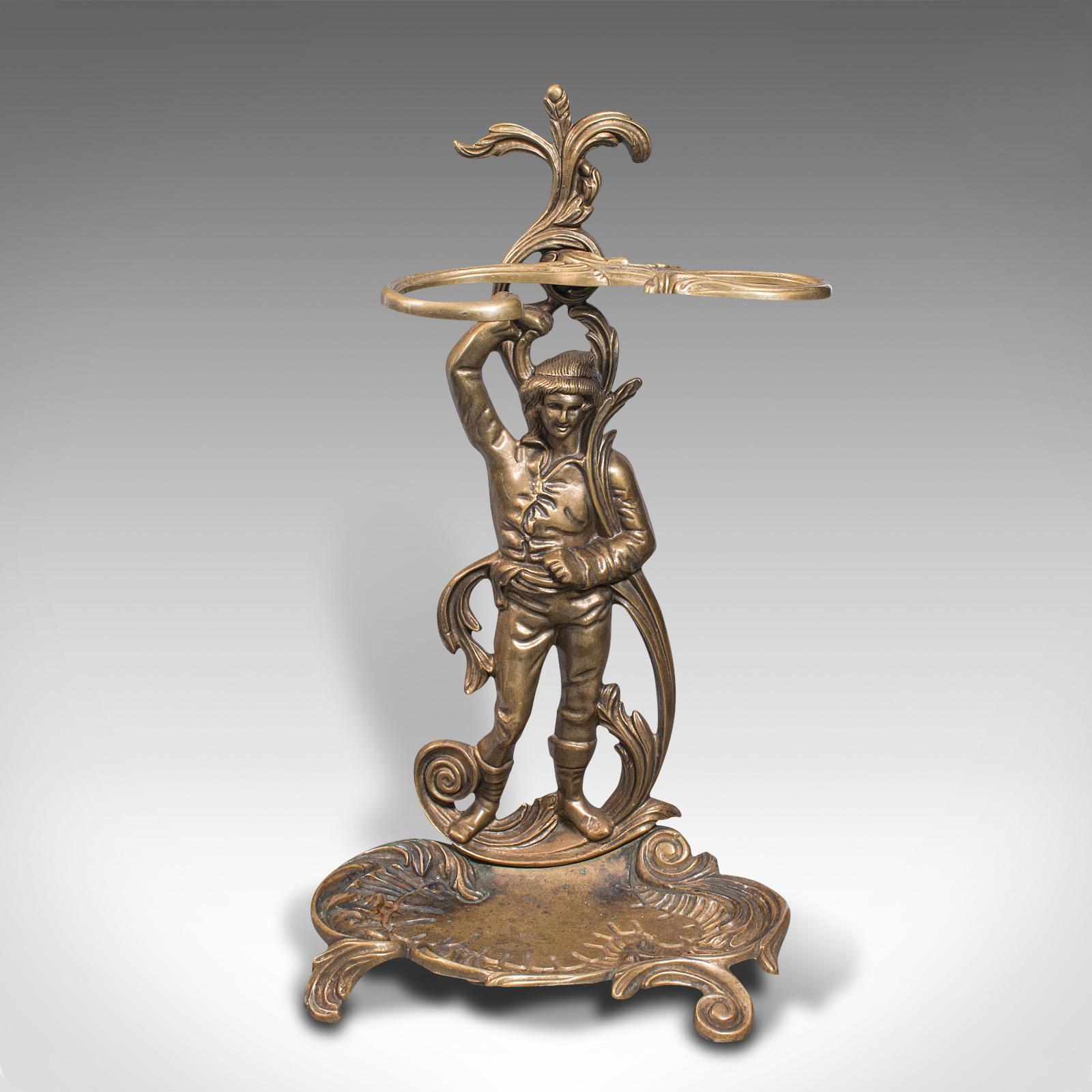 This is a vintage decorative stick stand. An Italian, pressed brass hall rack with figure, dating to the mid 20th century, circa 1940.

Enticingly charming hall stand with superb Art Nouveau overtones.
Displays a desirable aged patina and in good