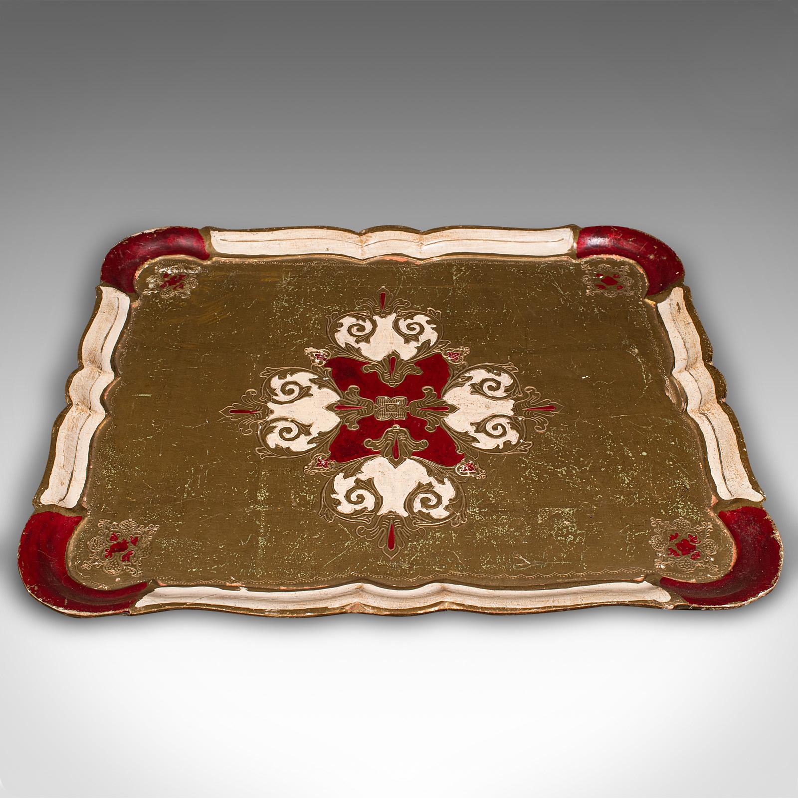 This is a vintage decorative tea tray. An Italian, gilt finished serving platter with Baroque revival taste, dating to the mid 20th century, circa 1950.
 
Striking colour and tonality creates a distinctive appearance
Displays a desirable aged