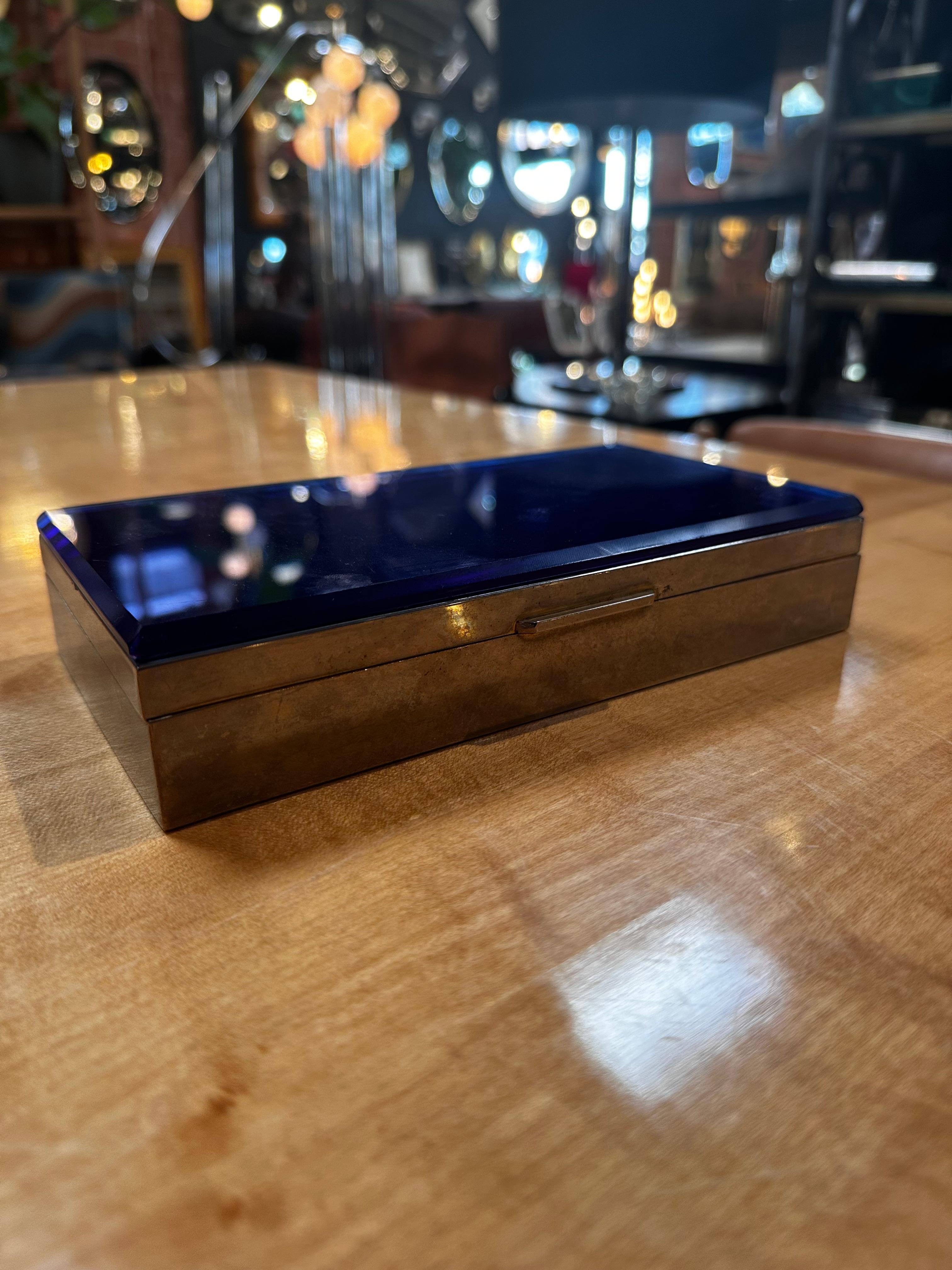 The Vintage Decorative Unique Blue Box from the 1960s, featuring a blue top glass and chrome base, is a stylish and distinctive retro piece. Crafted in the mid-20th century, the combination of the vibrant blue glass and sleek chrome base creates a