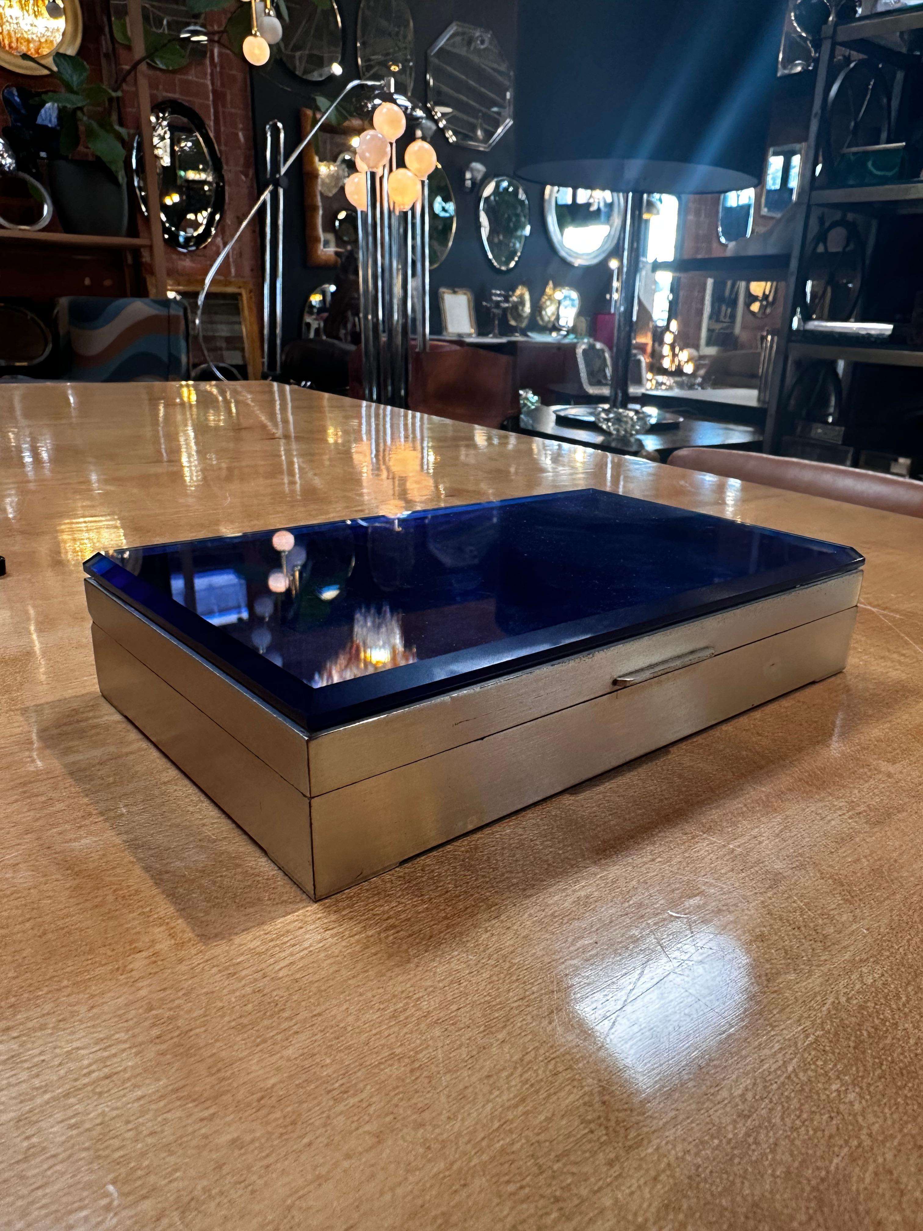 The Vintage Decorative Unique Blue Box from the 1960s, featuring a blue top glass and chrome base, is a stylish and distinctive retro piece. Crafted in the mid-20th century, the combination of the vibrant blue glass and sleek chrome base creates a