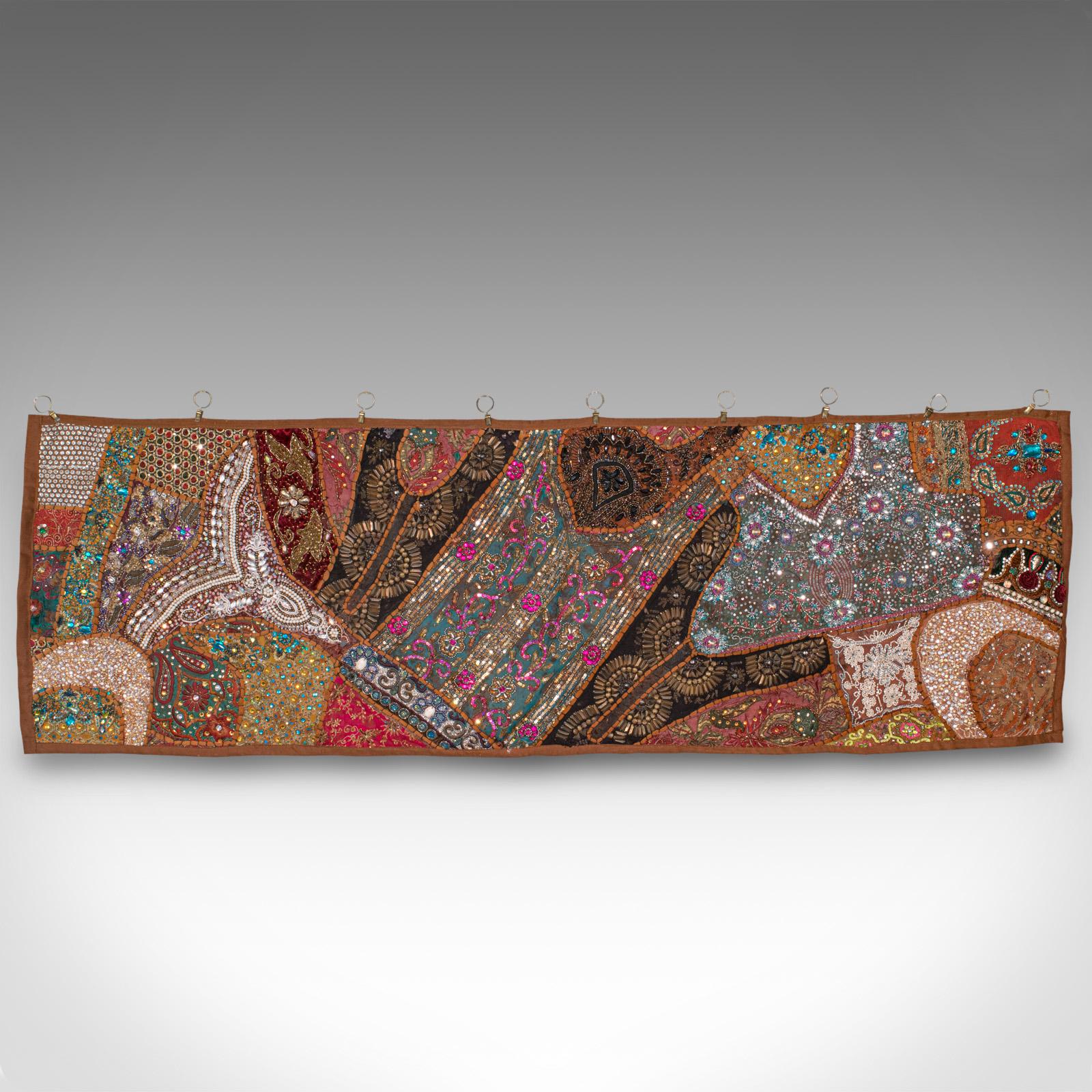 This is a vintage decorative wall panel. A Middle Eastern, ornate textile frieze with sequins and faux gemstones, dating to the late 20th century, circa 1980.

Eye-catching panel with great colour and highlights
Displays a desirable aged patina