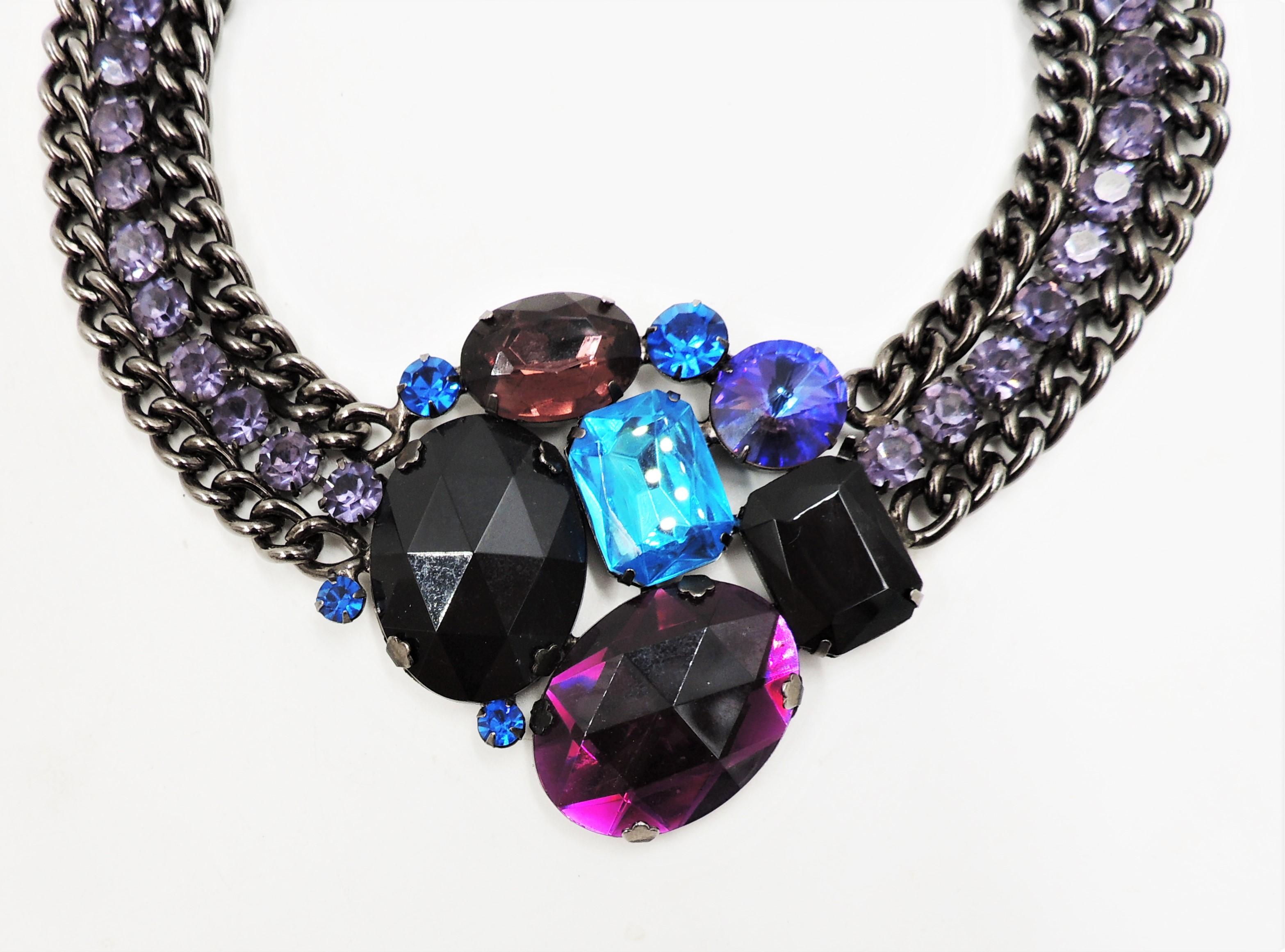Blackened Metal with huge, faceted blue, black and purple prong set rhinestones with smaller round prong set faux-amethyst collar necklace with box clasp. Marked 