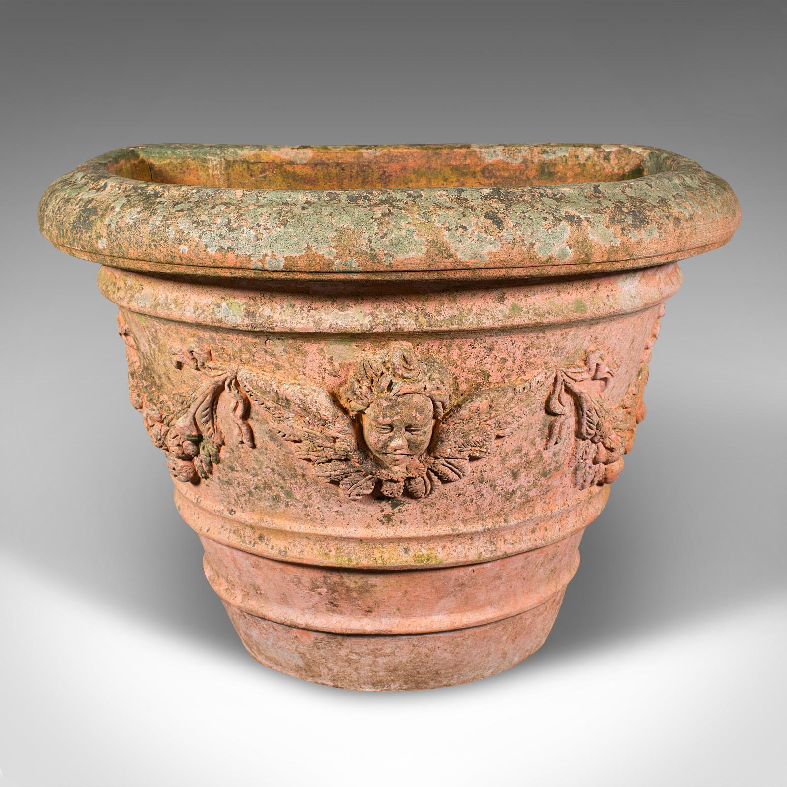 This is a vintage demi-lune planter. An Italian, weathered terracotta jardiniere, dating to the mid 20th century, circa 1960.

Substantial and nicely detailed planter with a lightly weathered appearance
Displays a desirable, naturally aged patina