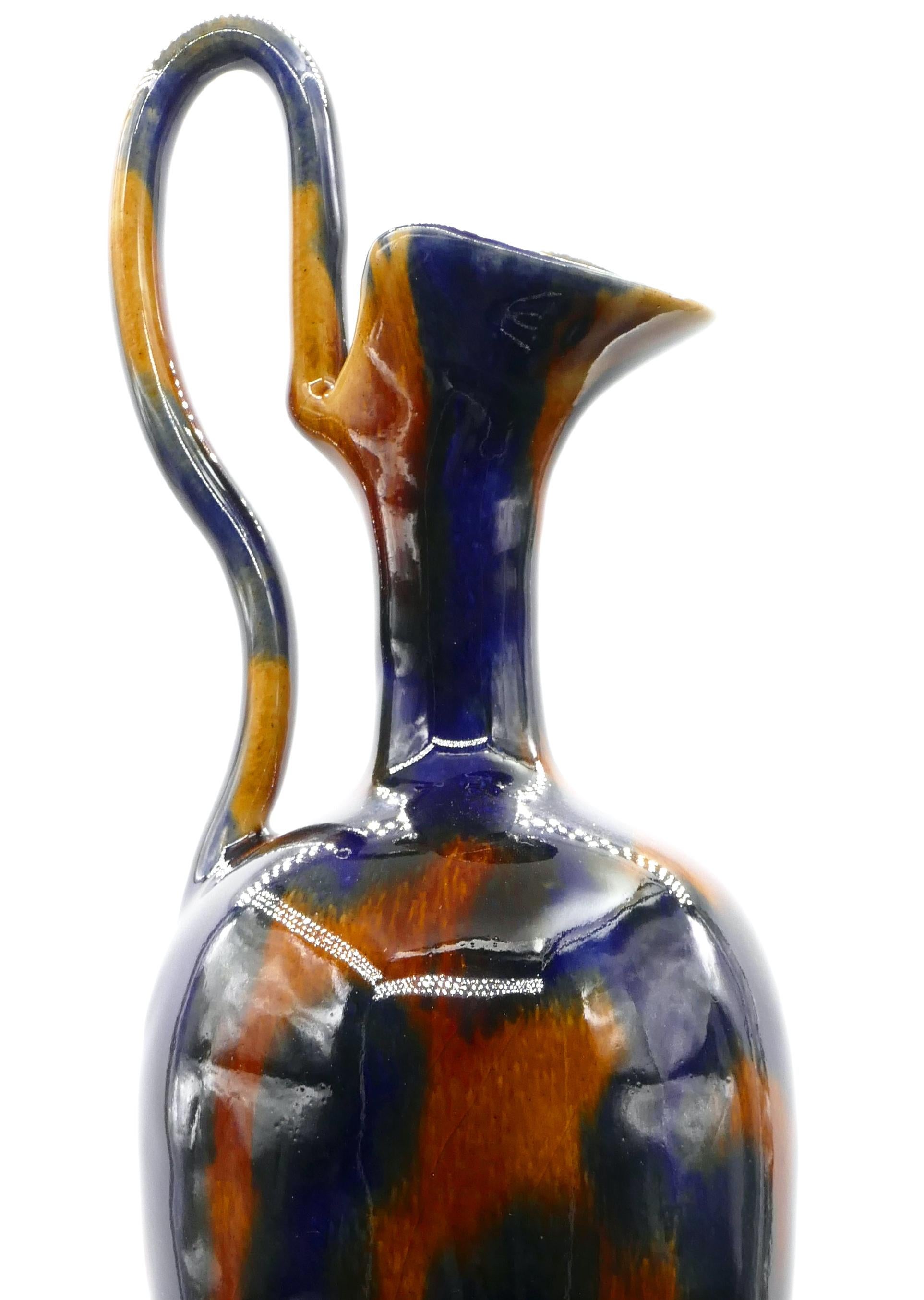 Vase with handle and spout is an original decorative object realized in the first half of the 20th century. 

Original colored glazed pottery. 

Made in United Kingdom by Denby Pottery. 

Mint conditions.

Fine 20th century work realized in