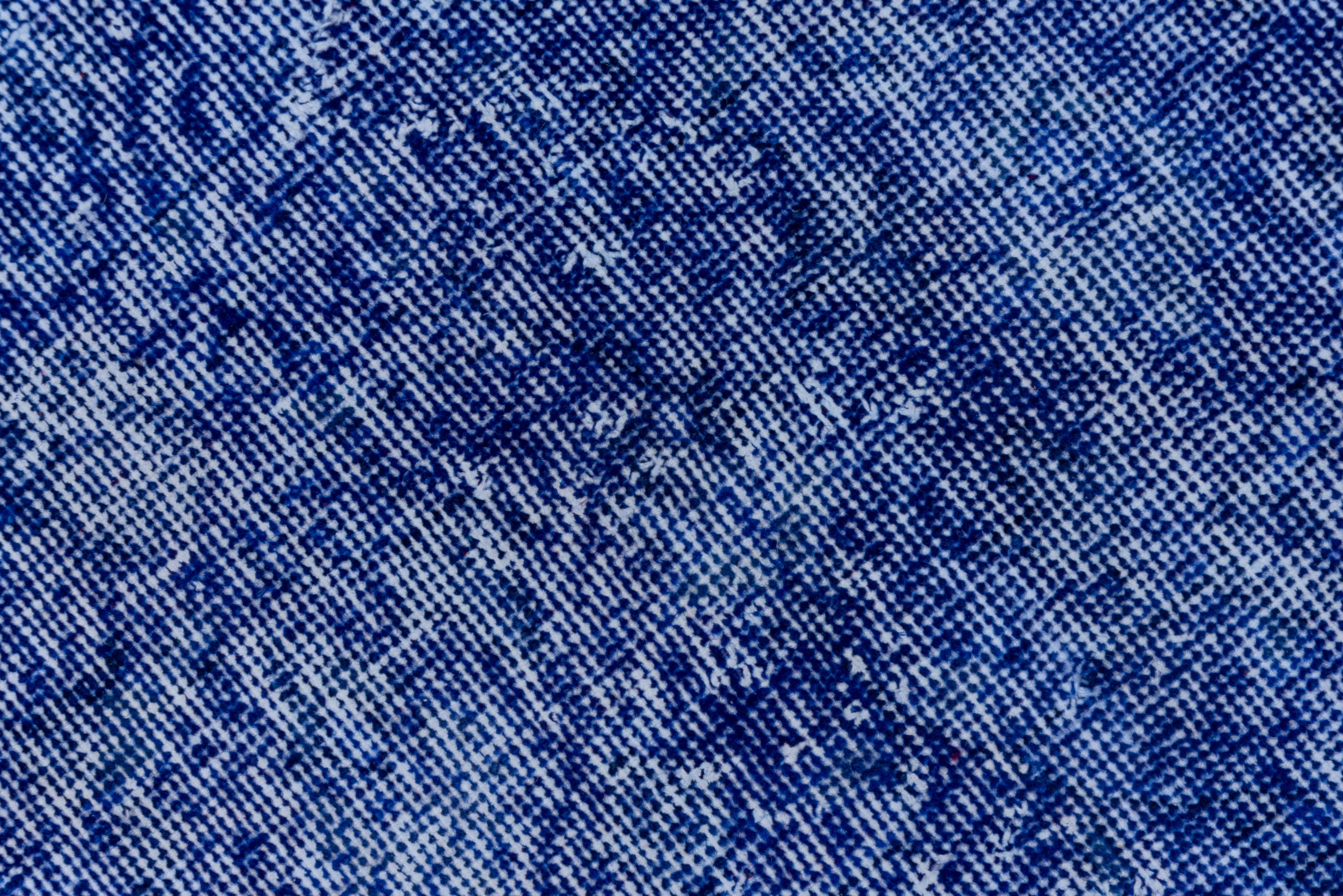 This indigo and denim blue Turkish overdyed sparta carpet has a pattern defined by the wear beyond the all-over general distress. Vertical and horizontal off white strips cross near the center. Shabby chic conditions and can offer some great texture