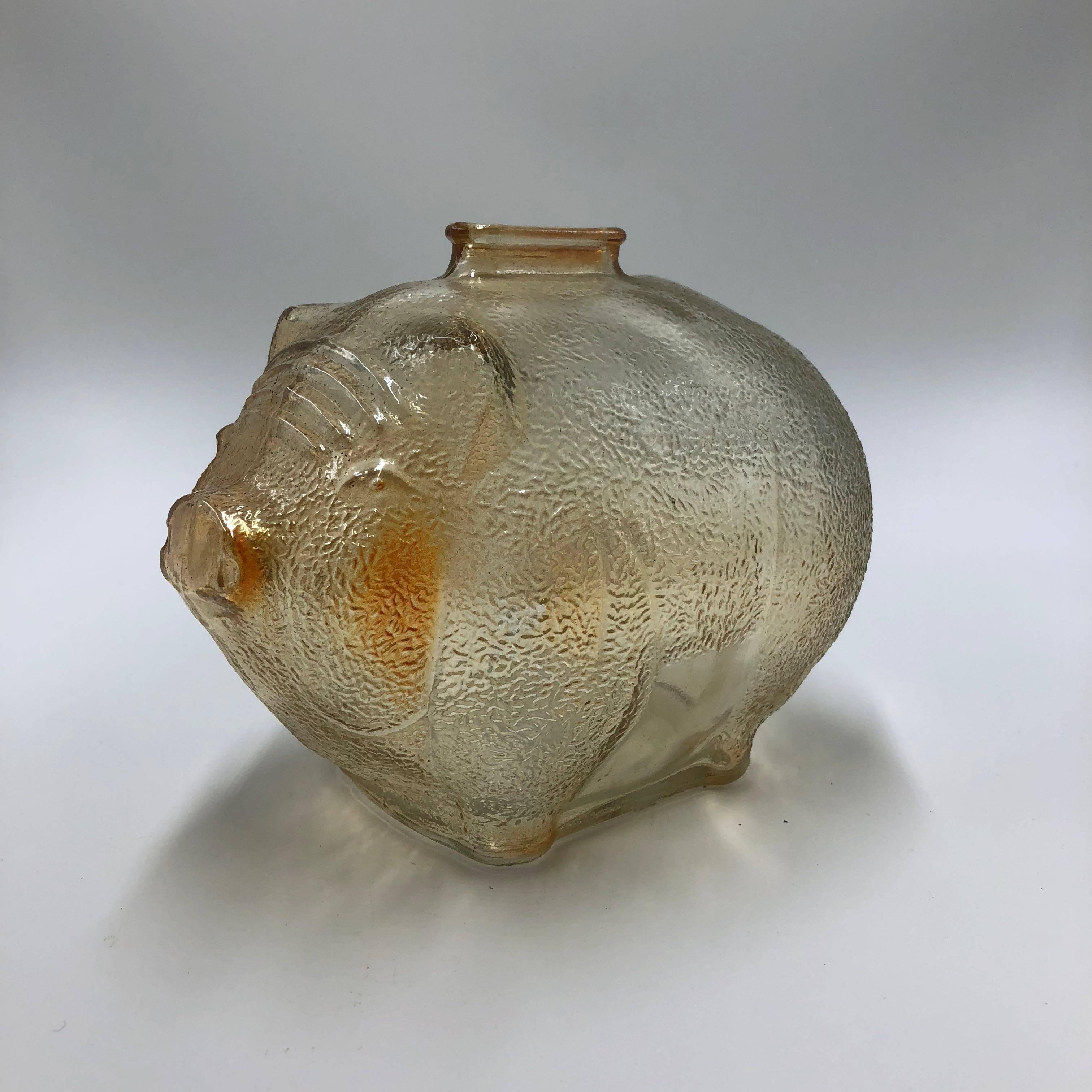 Vintage marigold iridescent glass piggy bank in good condition, a little over 10 cm long end to end.

Anchor Hocking piggybank. 