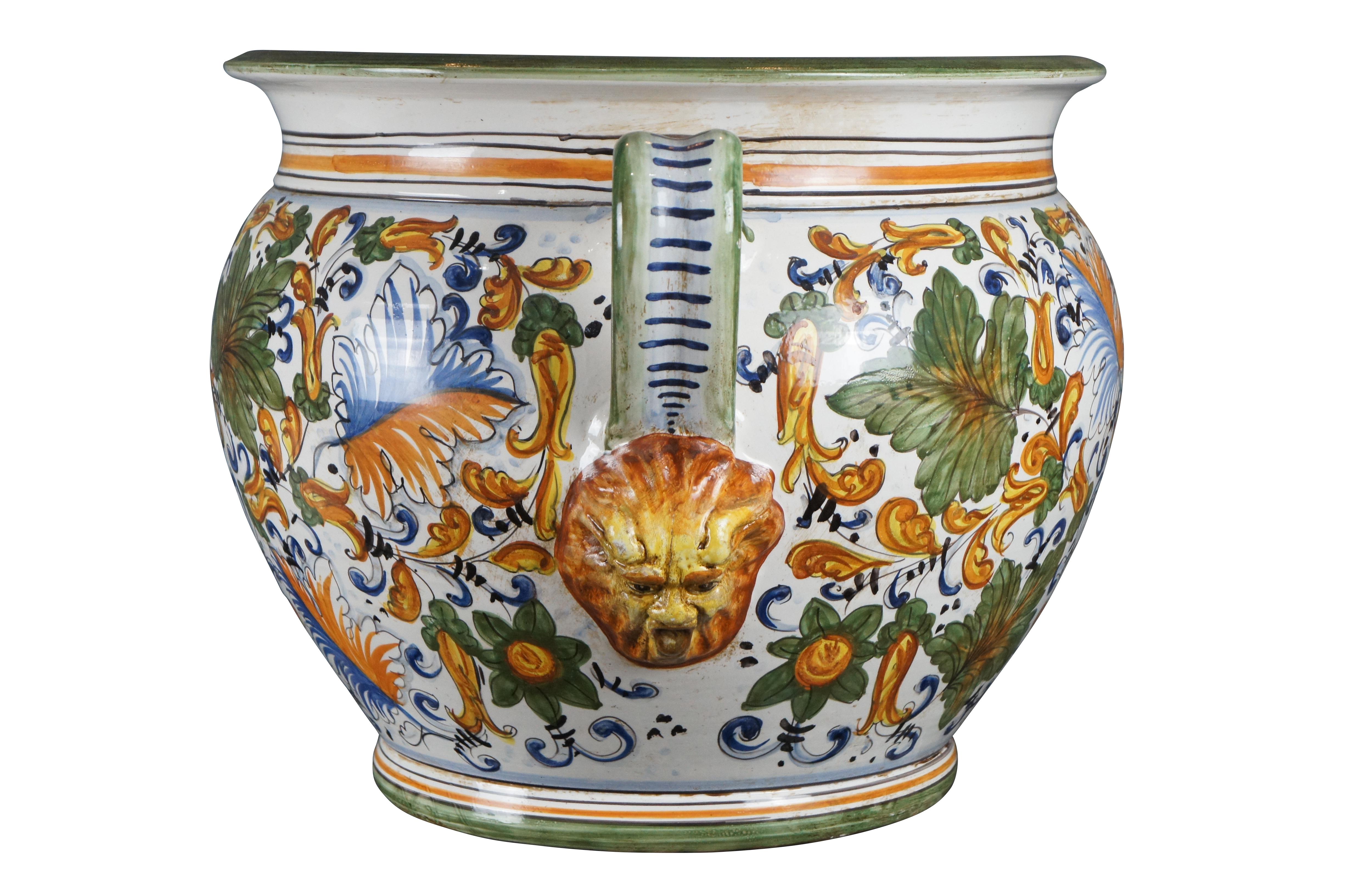 A beautiful 20th century Caffaggiolo jardiniere by Deruta pottery. Features a polychrome finish with elegant scrolling folitate motifs. The planter is handled with figural northwind face beneath. Exceptional craftmanship and color. Made in