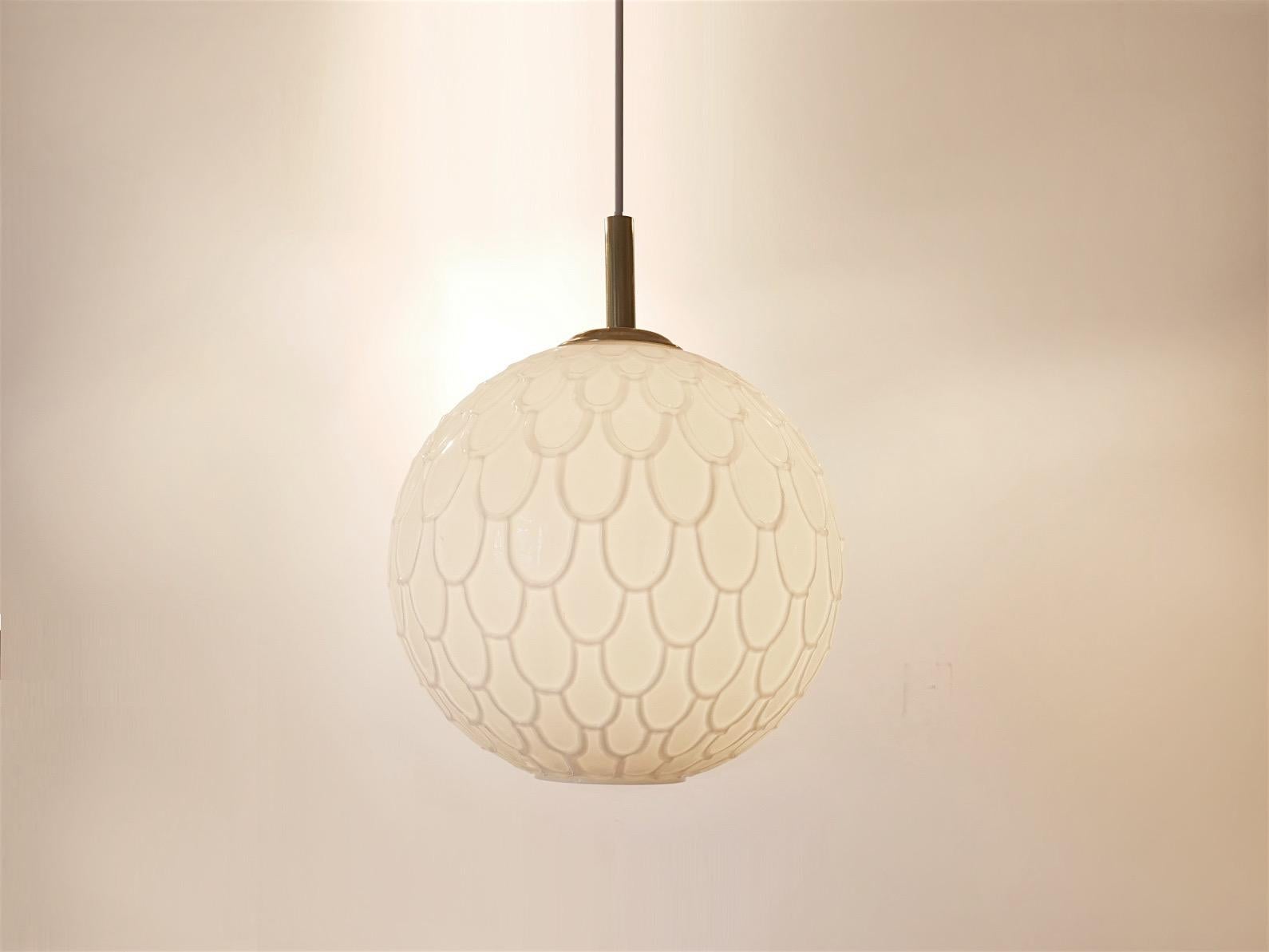 Peil & Putzler opalescent overglazed glass ball shaped pendant lamps with brass endings.



 