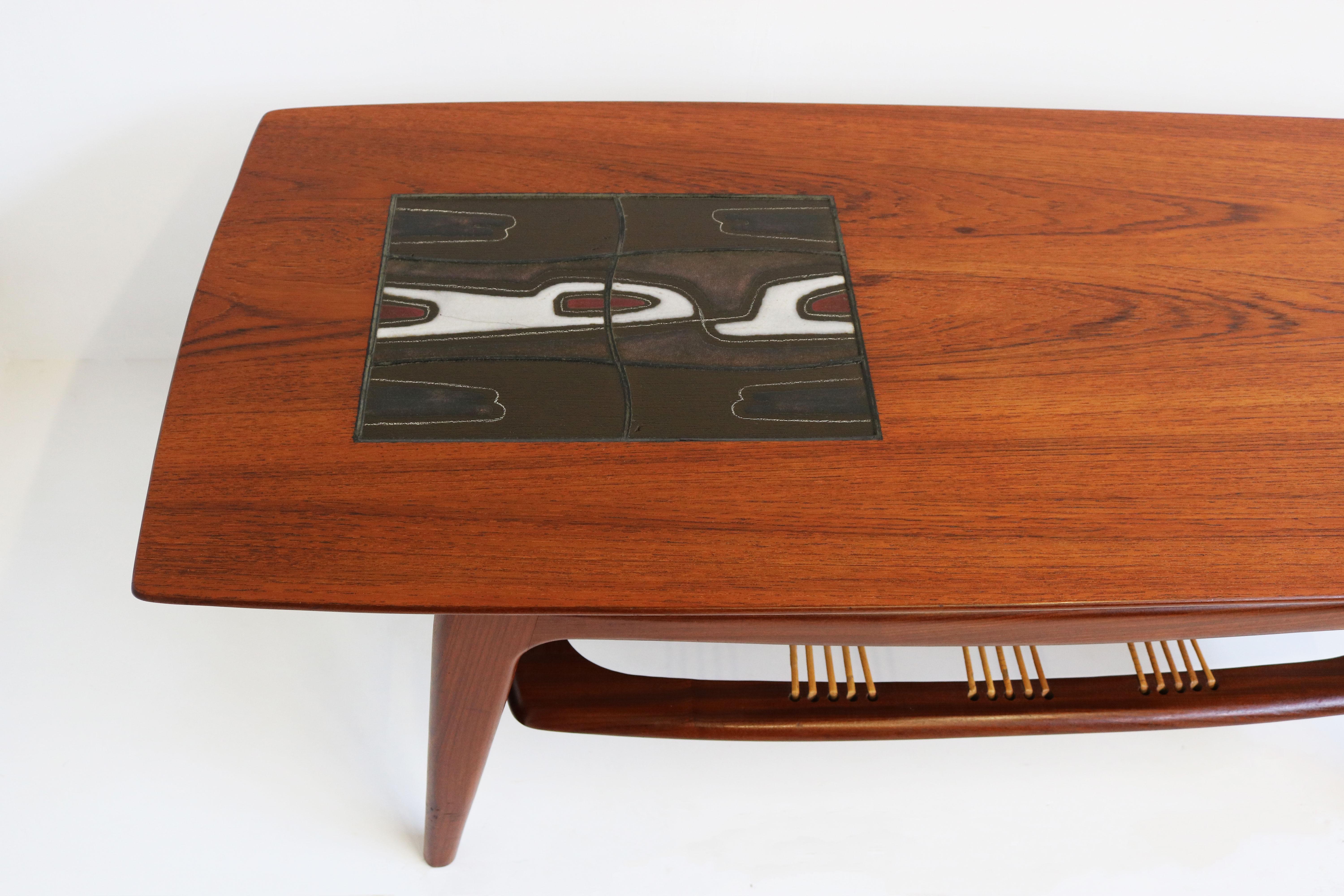 Dutch Mid-Century Modern design coffee table by Louis Van Teeffelen for Webe 1950. 
His most desired coffee table design with the unique combination of Teak , Rattan & Ceramic art. 
Gorgeous organic sculpted teak frame with original rattan