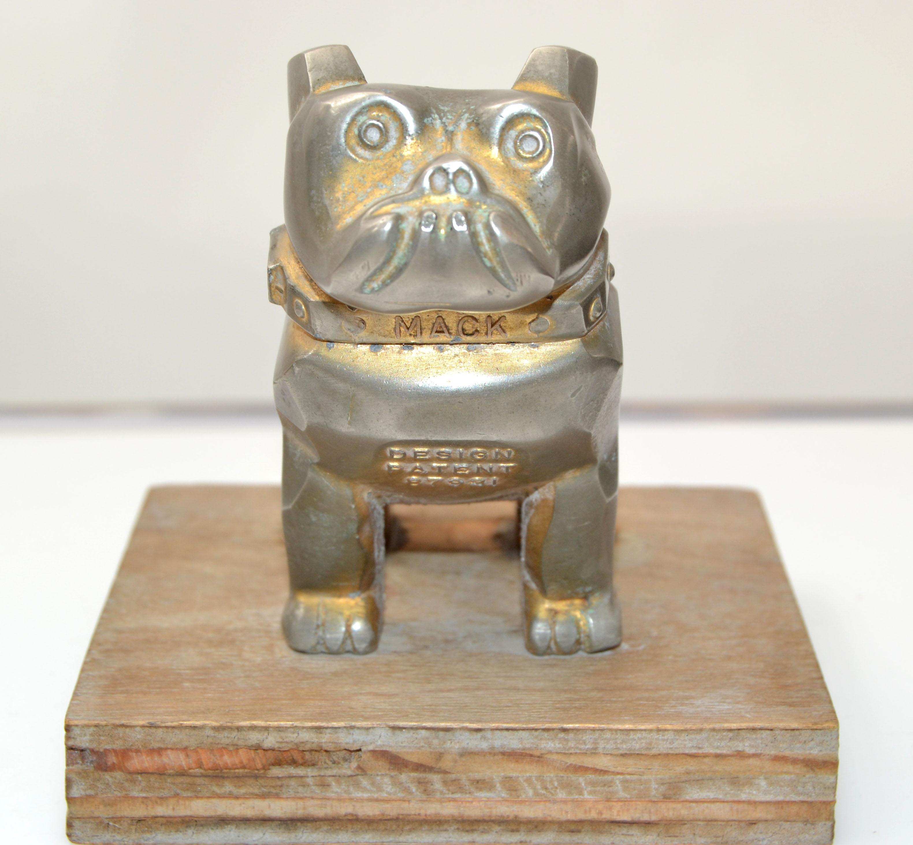Vintage Design Patent Mack trucks bull dog figurine, statue, animal sculpture.
Silvered Bronze Bull Dog mounted on a wooden Base.
Marked Mack, 87931, Design Patent.
Base measures: 4.25 x 4.25 x 0.75 inches.