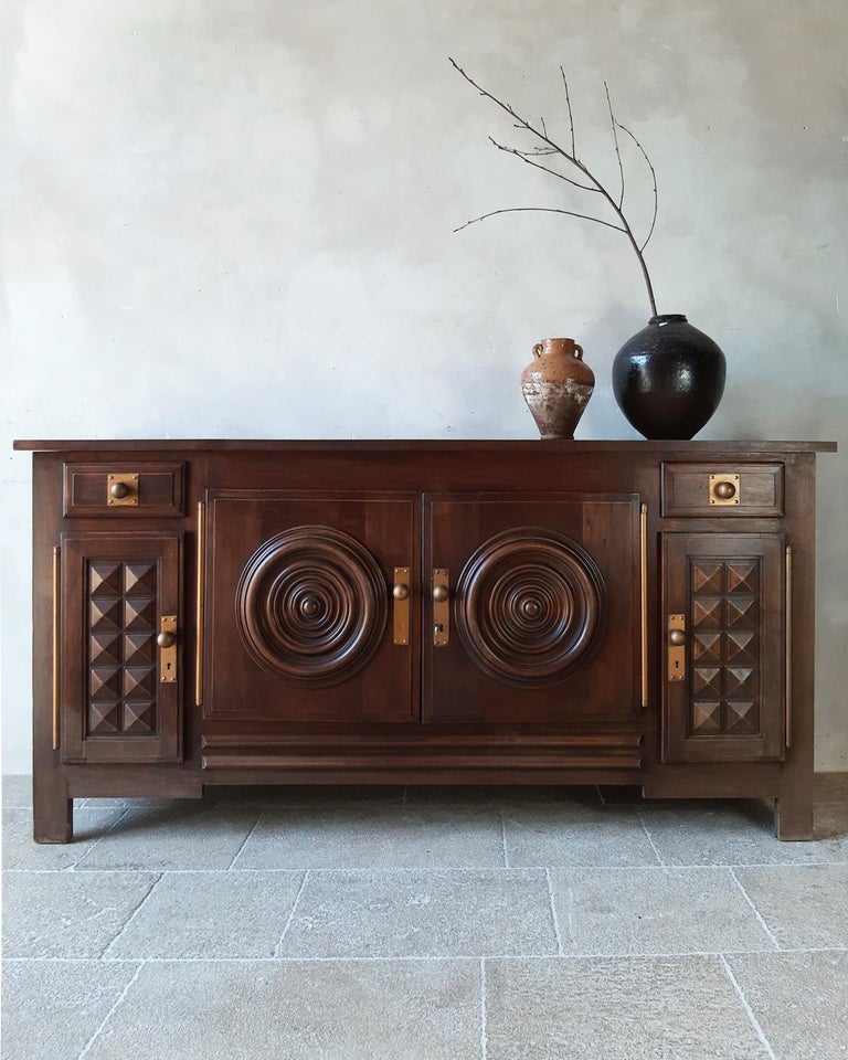 Vintage design sideboard by Charles Dudouyt in oak, 1940s-50s. The doors of this beautiful sideboard are cut out in graphic and geometric shapes.

Dimensions: H 106.5 x W 220 x D 55.5 cm.