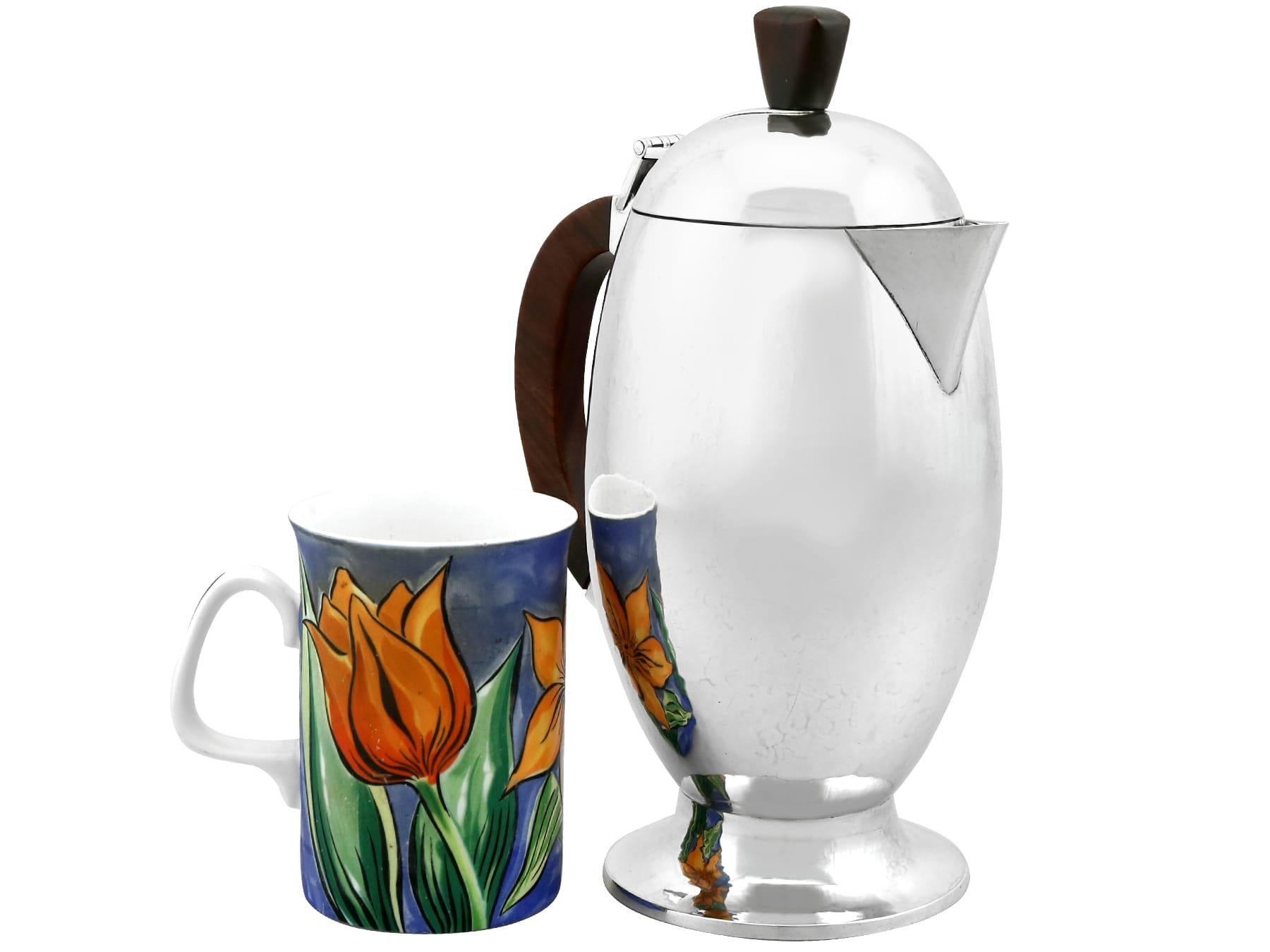 An exceptional, fine and impressive vintage Elizabeth II English sterling silver coffee jug in the Design style; an addition to our silver teaware collection

This exceptional, fine and impressive vintage sterling silver coffee jug has a plain