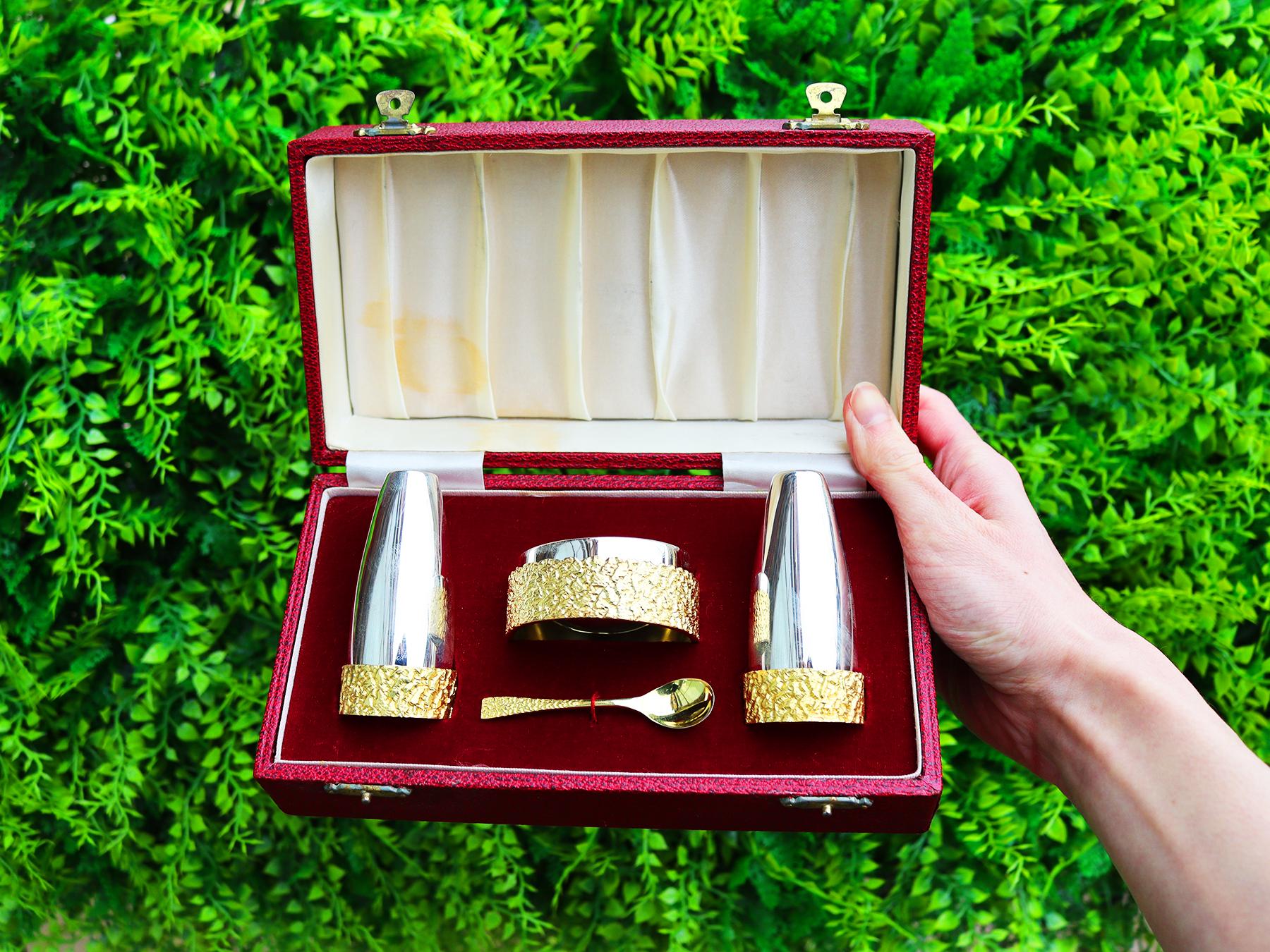 A fine and impressive vintage Elizabeth II English sterling silver three piece condiment set in the Design style - boxed; part of our boxed condiment sets collection.

This fine and impressive vintage condiment set, in sterling silver, consists of a