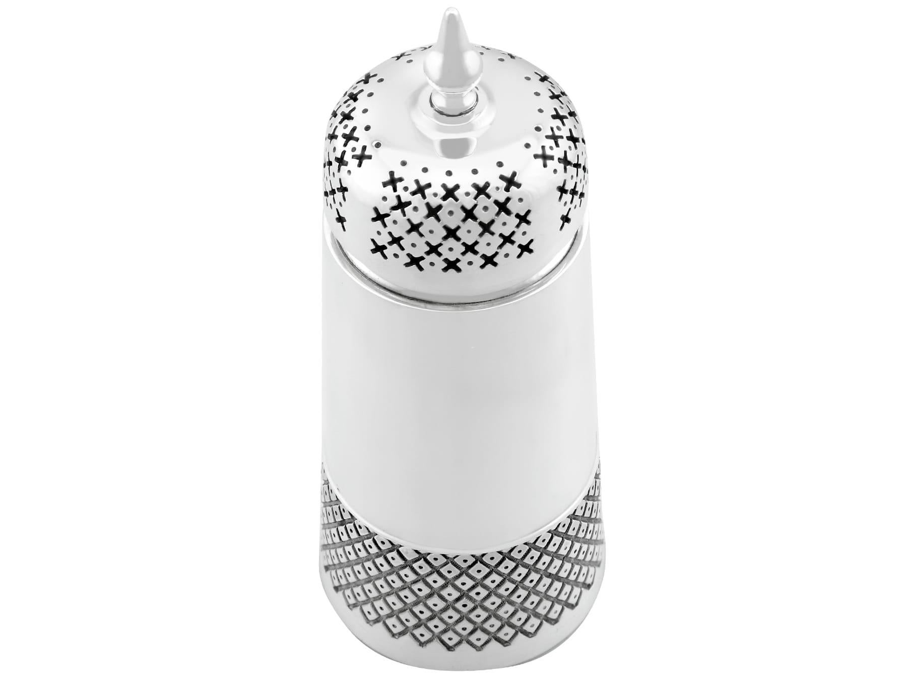 An exceptional, fine and impressive vintage Elizabeth II English sterling silver sugar caster in the Design style; an addition to our silver teaware collection

This exceptional vintage English sterling silver caster has a tapering cylindrical