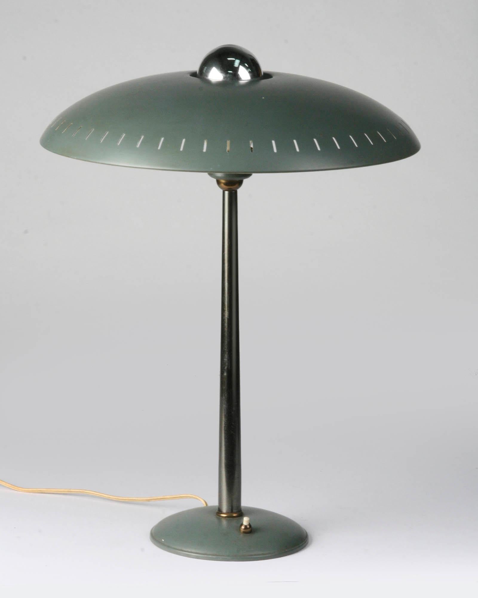 Nice vintage design lamp, released by Philips in the 1950s of the 20th century. The lamp is a design by Louis Kalff, he has made many designs for Philips and the characteristic round flat shape is reflected in many of his works. The lamp is in good