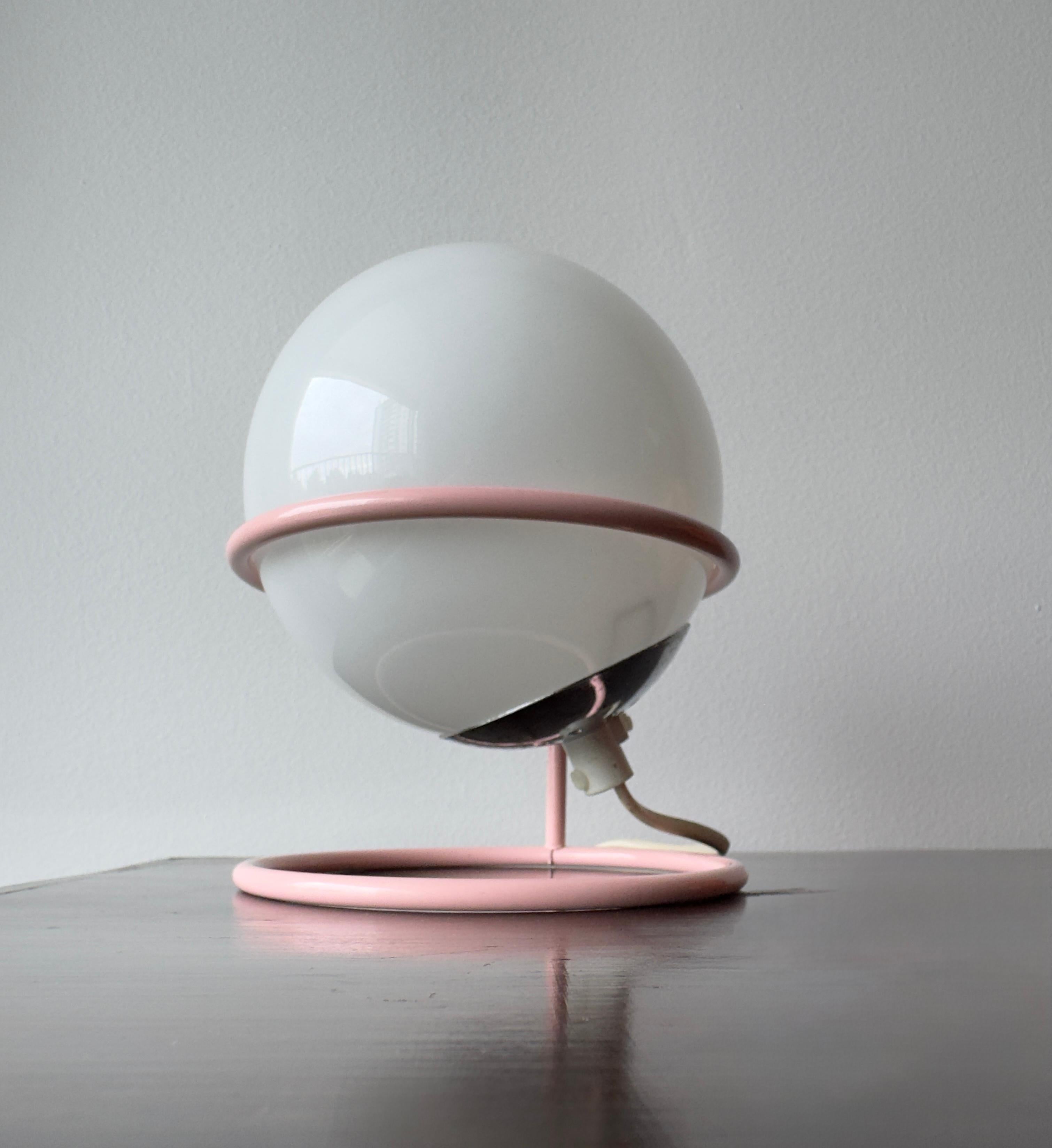 Vintage lamp from the 1970s/1980s.
White opaline globe resting on a pink lacquered metal frame; in the style of Aldo van den Nieuwelaar's work or the Memphis design movement.