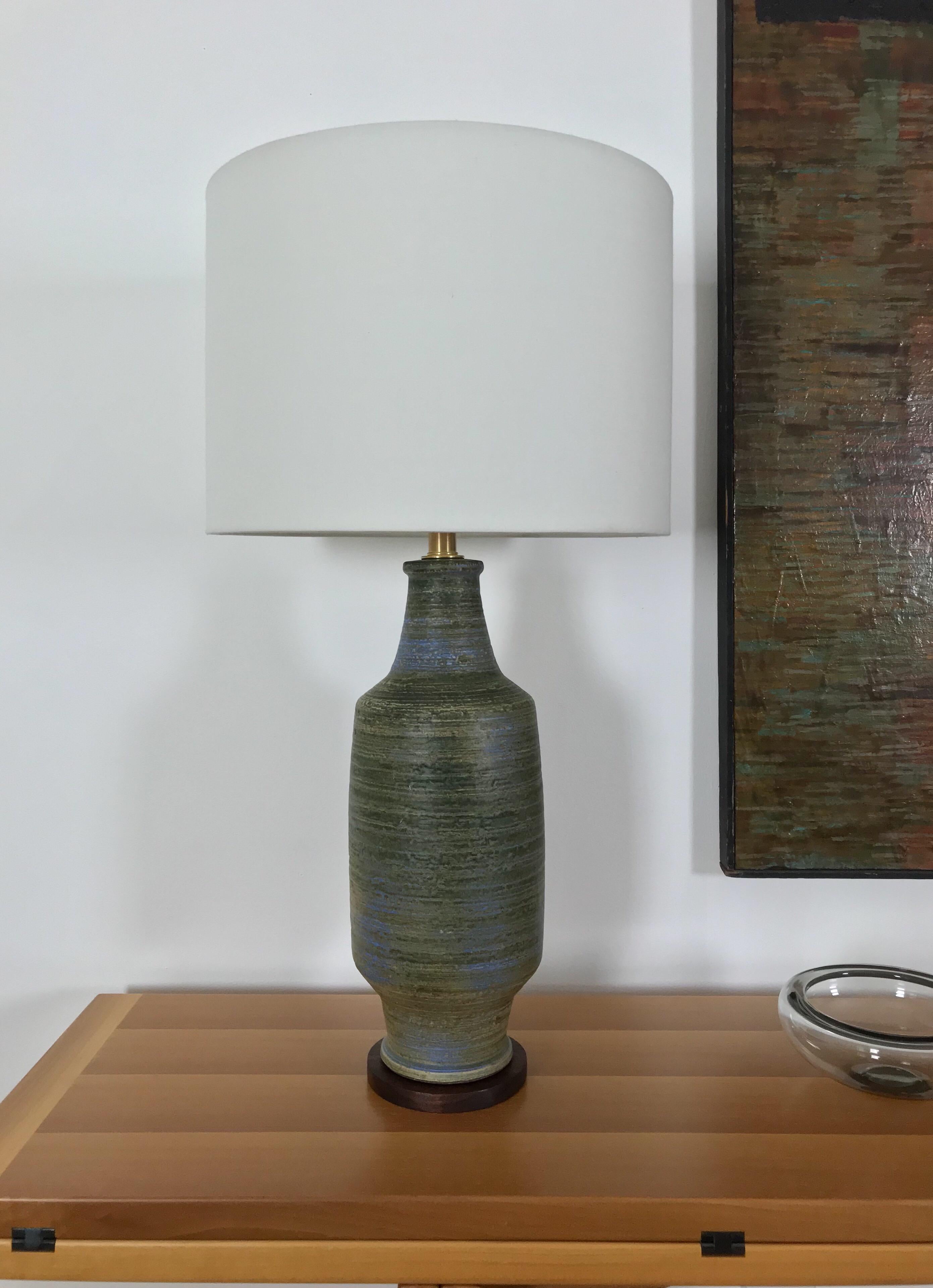 A vintage ceramic lamp with a solid walnut base designed by Lee Rosen for Design Technics. The early lamps had a paper label near the cord hole, so I believe this lamp is from the late 1950s, early 1960s. The lamp has been taken apart and cleaned,