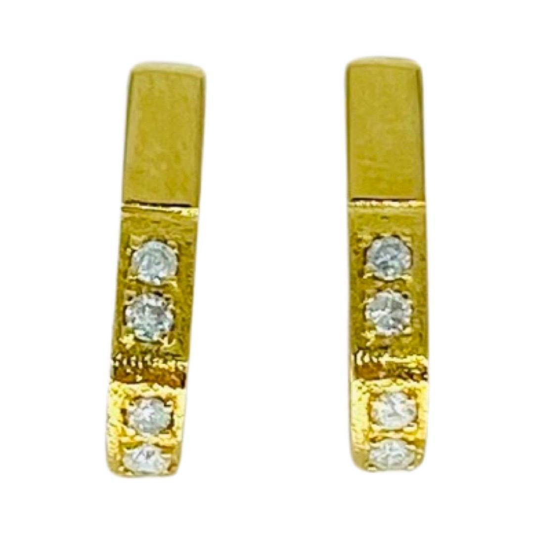 Vintage Designer 0.20 Carat Diamond Hoop Earrings 18k Gold. Unique designed earrings featuring 8 round cut brilliant diamonds in total for a combined weight of approx 0.20 carat. The earrings measure 20mm in height and 4mm wide. The earrings weight