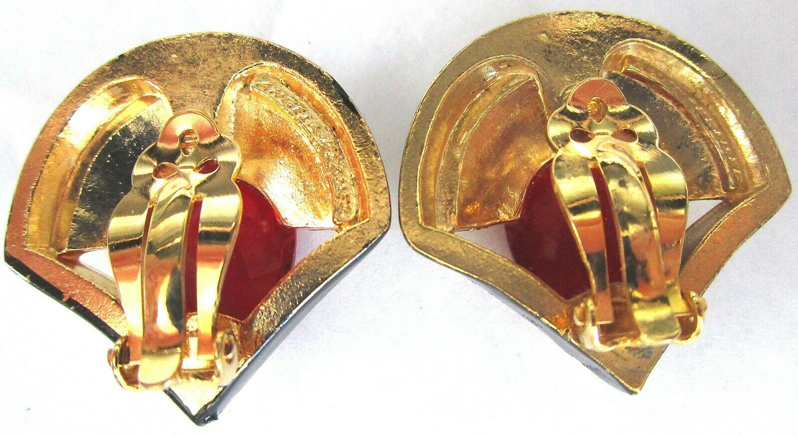 Beautiful Modernist design Clip-on Earrings. Each set with Yellow Baguettes and Red Teardrop CZs, enhanced with Black Enamel surround. Gold plate mounting. Measuring approx. 1.25