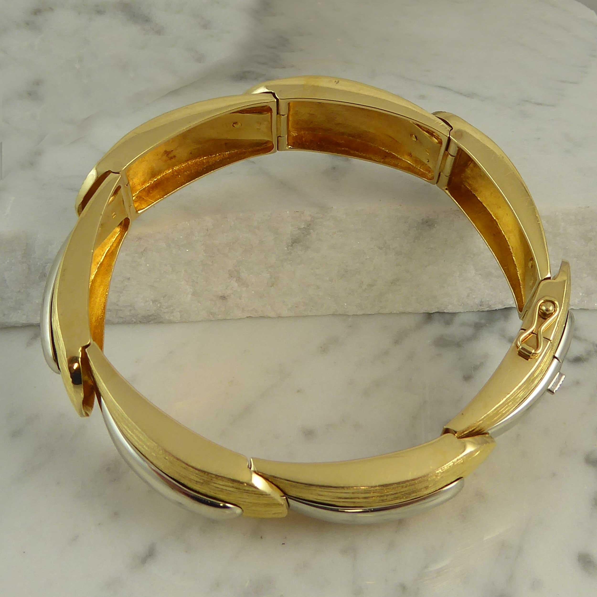 A vintage gold bracelet from the Finnish design house, Lapponia.  Fashioned in 18ct yellow and white gold, the bracelet comprises seven curved, overlapping links of 18ct yellow gold that have been given a textured, grooved pattern and each section