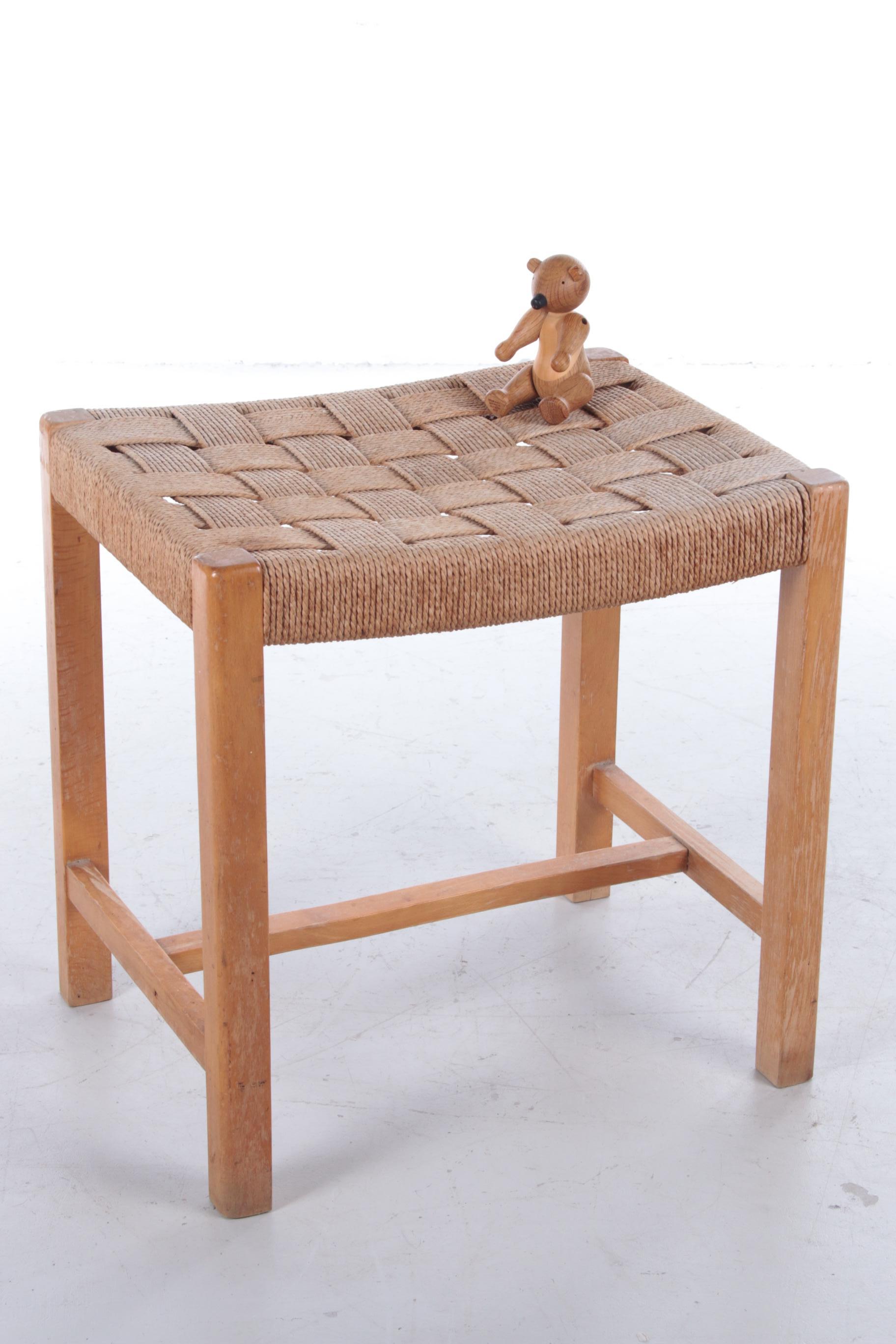 This is a beautiful vintage stool from Denmark, produced in the 1960s.

The frame is made of sturdy teak and the seat is made of woven sea grass. This is slightly thinner than cane and gives the stool a subtle and simple look.

This handmade
