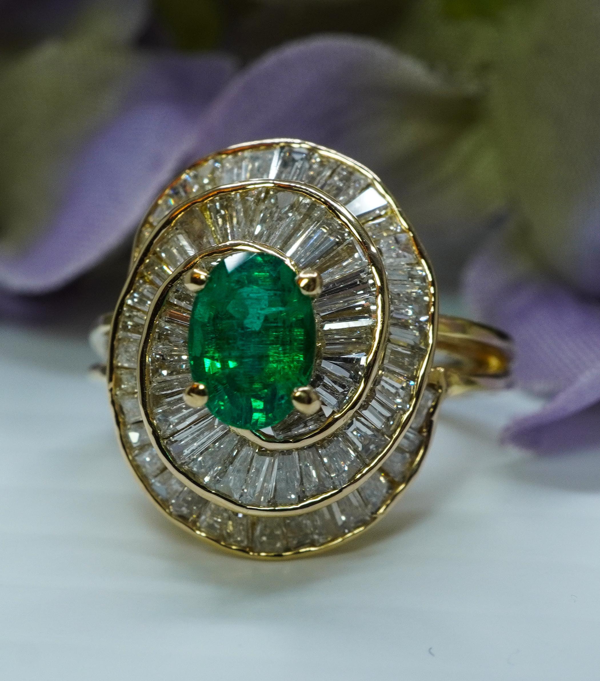    Vintage Designer Emerald Baguette Diamond 18K Gold Swirl Ring Estate
 
This luxurious vintage piece is attributed to Oscar Heyman Brothers, but there is no stamp, just 18K stamp. It holds a genuine earth mined vibrant green emerald and