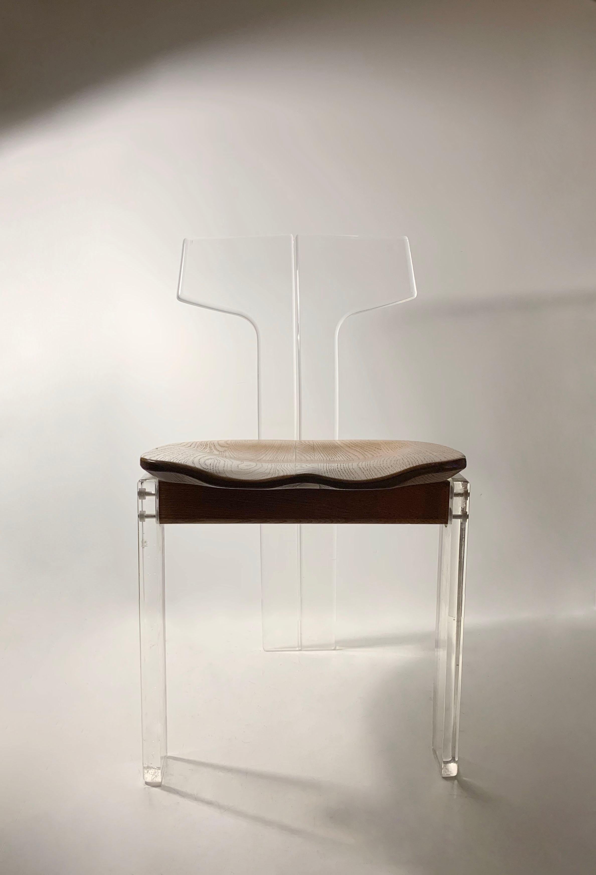 A Vintage designer lucite t-back side chair or desk chair. Very high quality well made forms. Uncertain to designer or origin. Possibly Italian. Style of Kagan