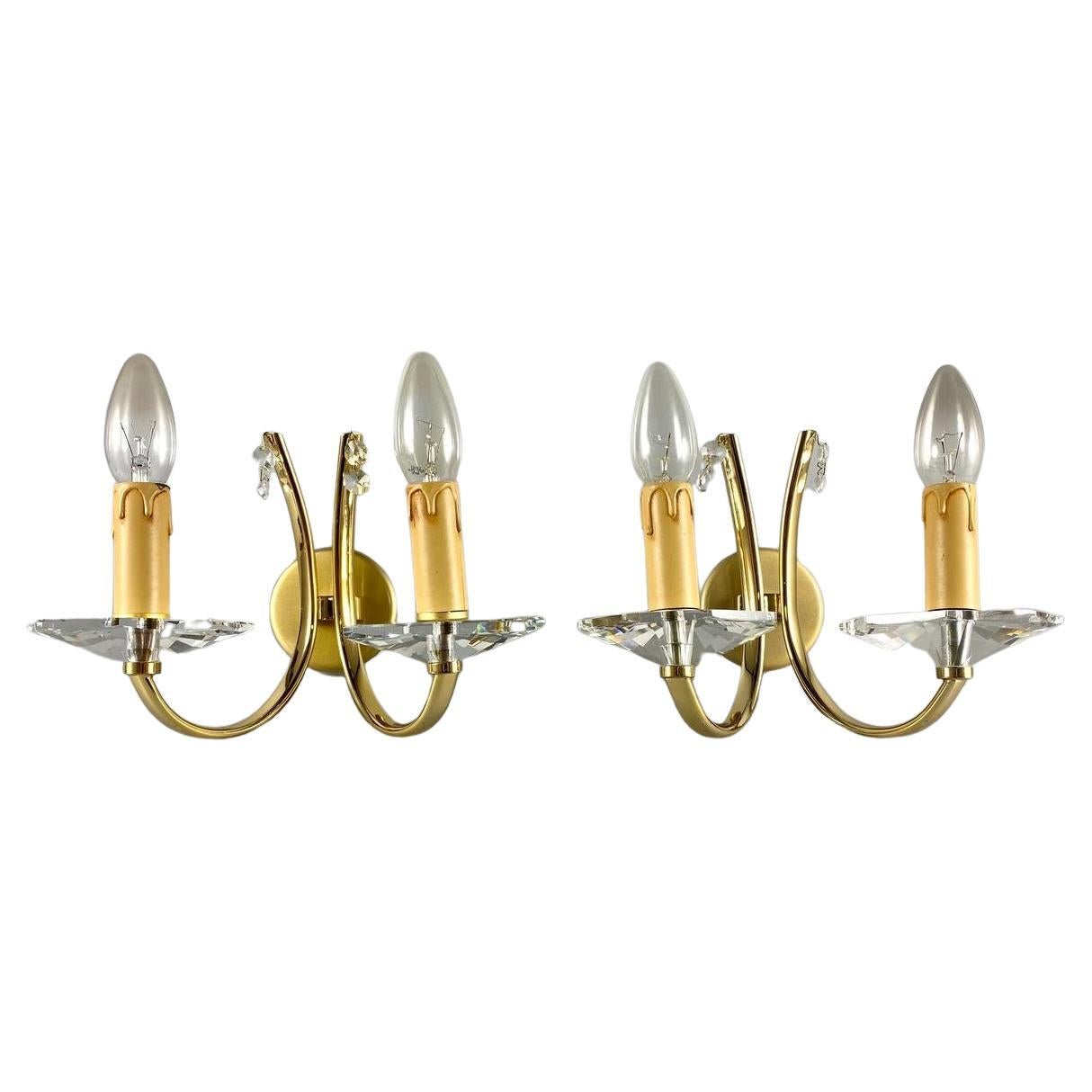 Paired designer wall sconces in gilt brass and crystal elements from the famous Portuguese company Candeeiros Castro.

 Vintage Designer Wall Lighting with 2 horns.

 Very noble and sensual! Such a wall lamps will effectively complement the