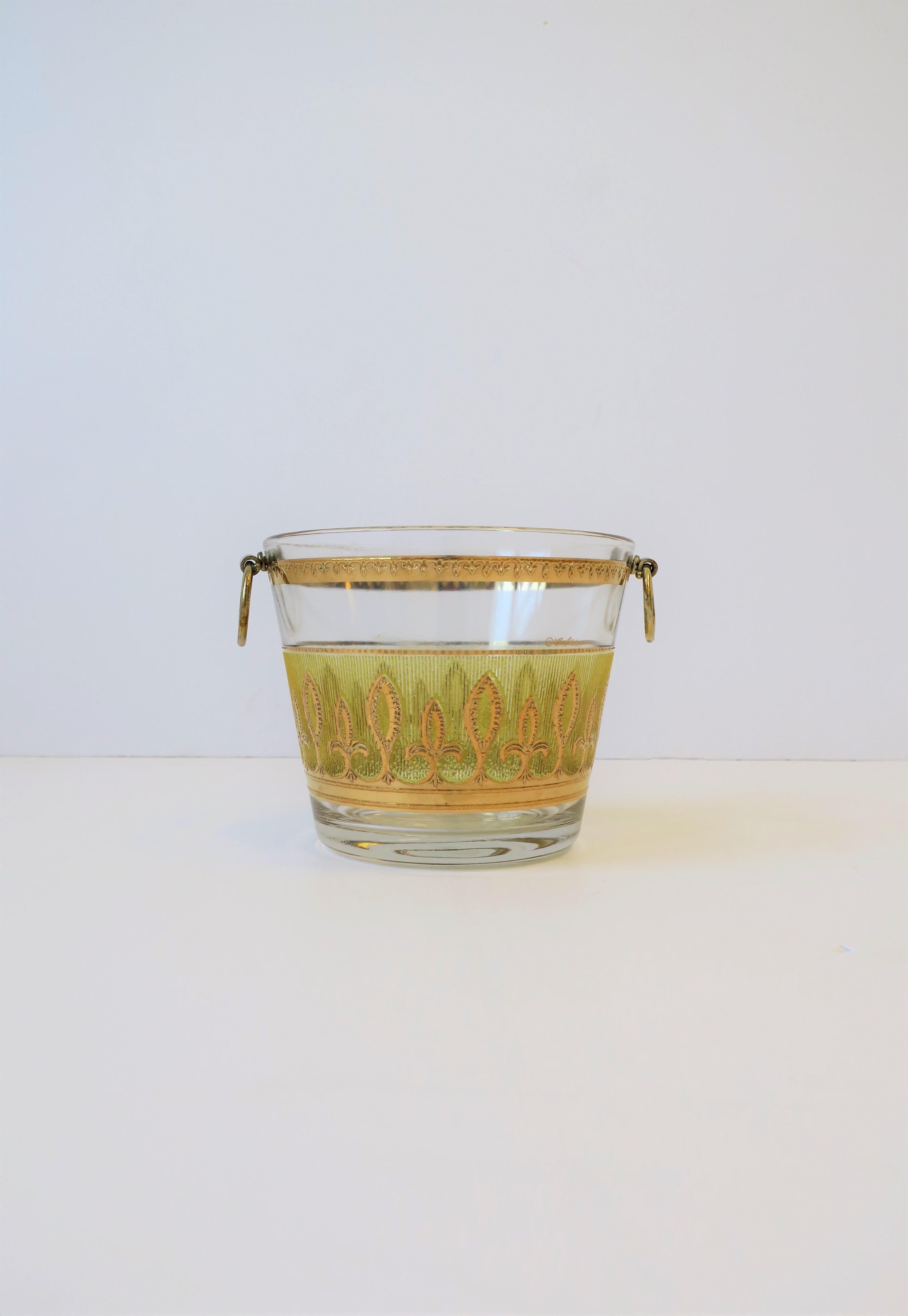 A vintage canary yellow and 22-karat gold ice bucket (or wine cooler) with gold-tone loop handles and a Fleur-de-lis design, in the Hollywood Regency style, by Culver, Ltd., circa mid-20th century, 1960s, Brooklyn, New York. Great for entertaining,