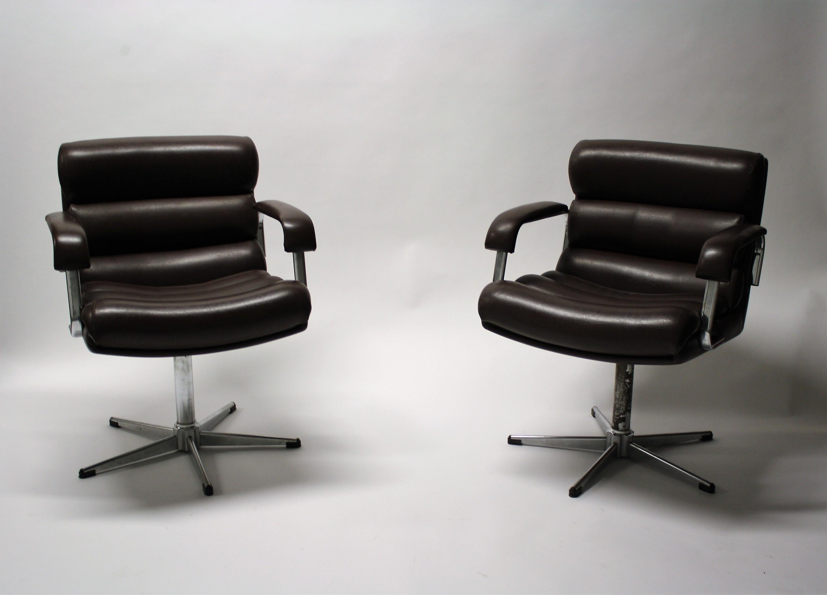 Pair of vintage skai desk chairs or lounge chairs.

The chairs consist of six individual cushions and armrests made of brown skai which makes the chairs very comfortable to sit in.

They have aluminum star shaped bases.

Good condition.

One
