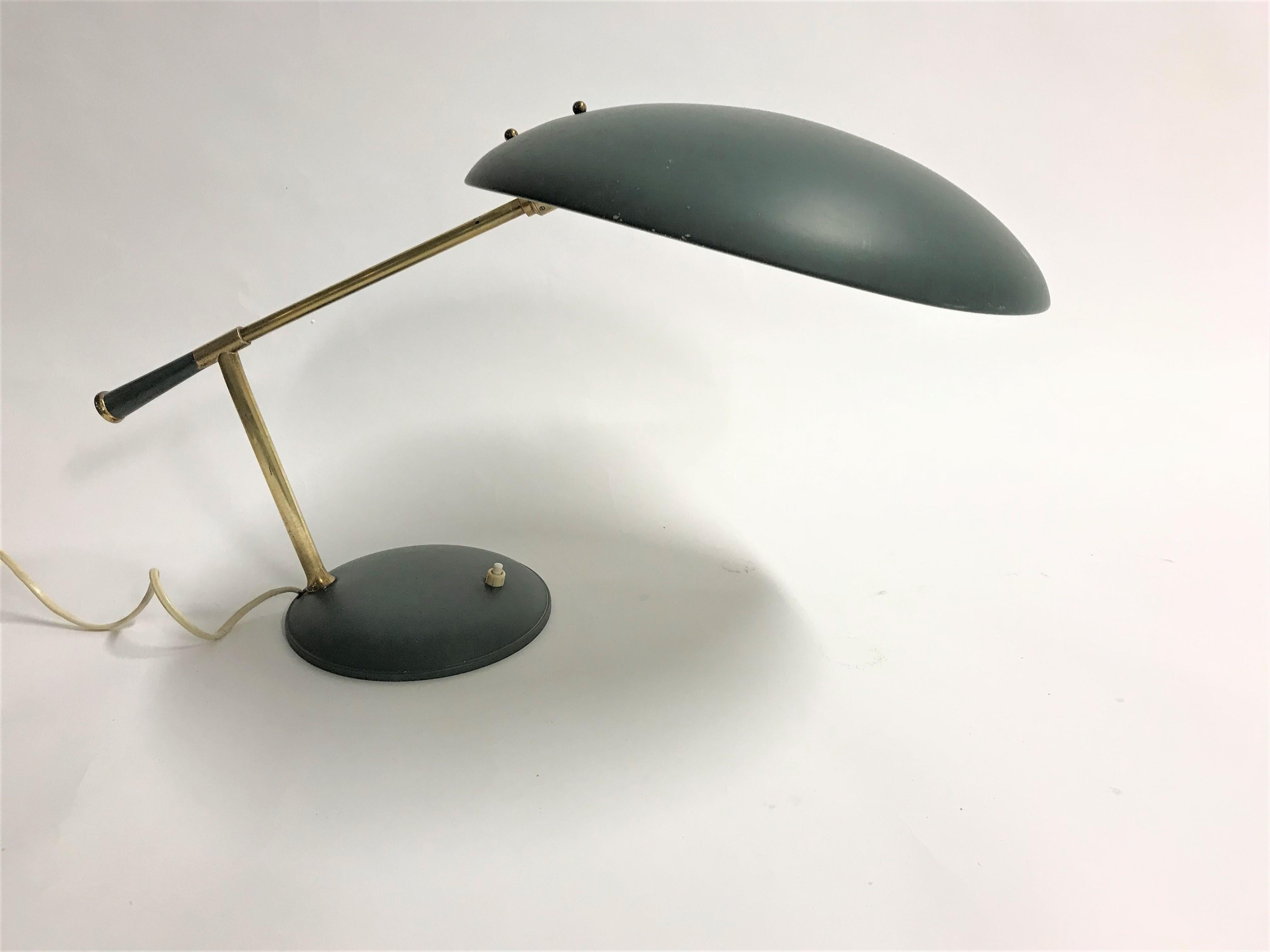 This midcentury table lamp has a beautiful design and is rather unique.

Louis Kalff made some famous designs like the Timor desk lamp or the 'z' shaped desk lamp.

This one we never encountered.

The angle of the shade is adjustable in order