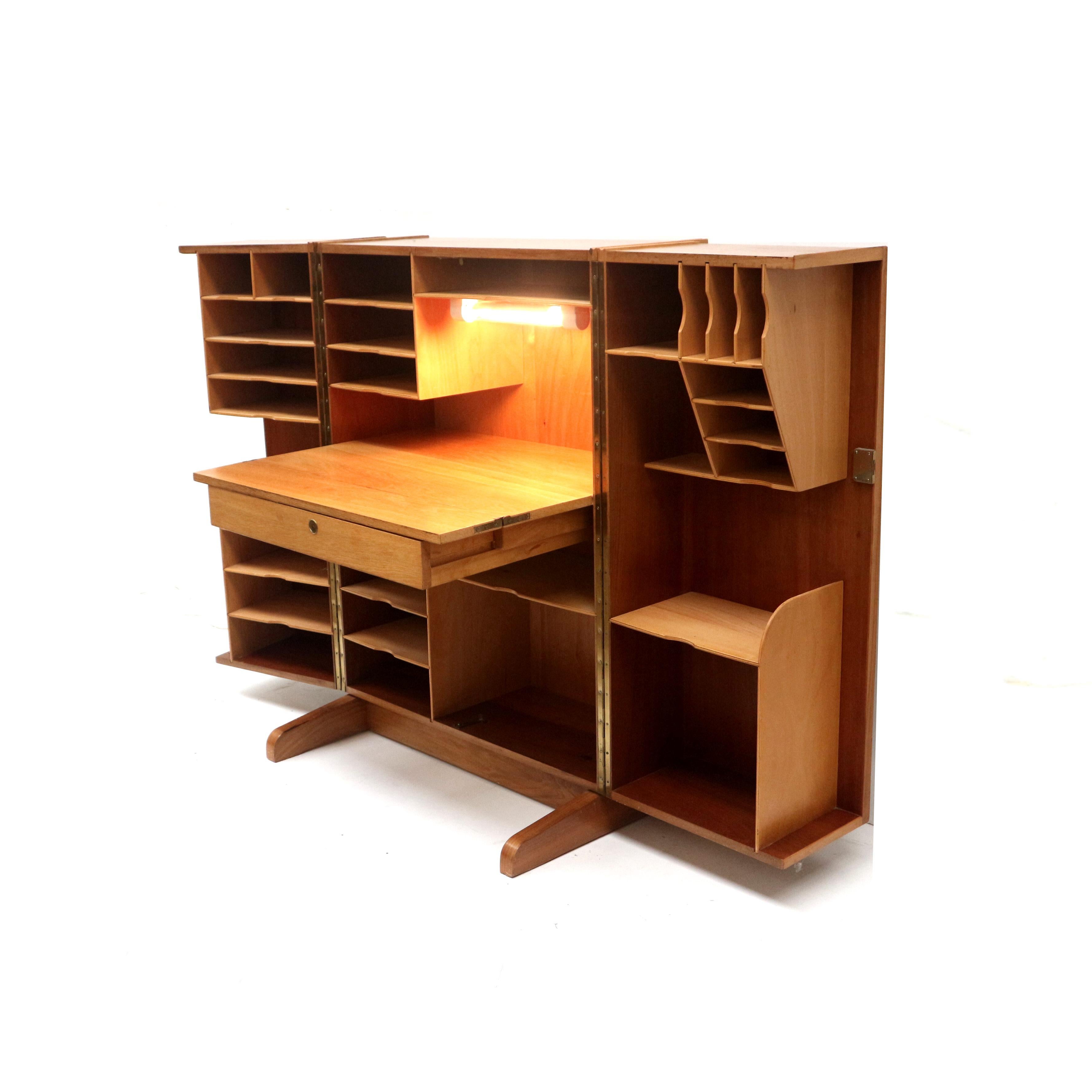 Vintage desk  ‘Magic Box’ designed by Mummenthaler & Meier in 1955.

This cabinet dates from 1955 and is also called the Magic Box. Designed by Mummenthaler & Meier from Switzerland. It is a cabinet with two doors that “unfold” completely. With