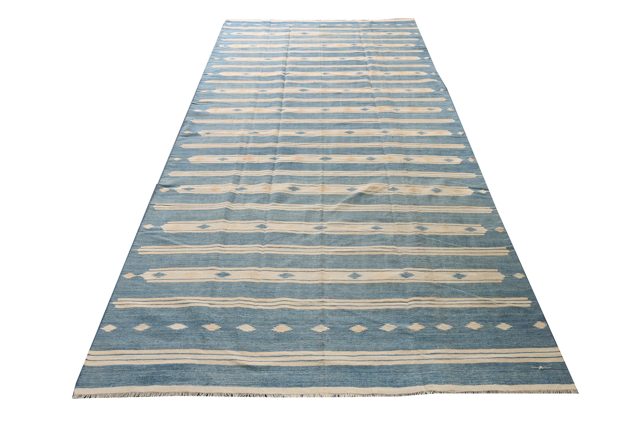 Dieser Vintage-Dhurrie im Format 5×11 ist ein aufregender Neuzugang in der geschätzten Flachgewebekollektion von Rug & Kilim. Es ist aus Baumwolle handgewebt und stammt aus Indien (ca. 1950-1960). 

Über das Design:

Dieses Flachgewebe entfaltet