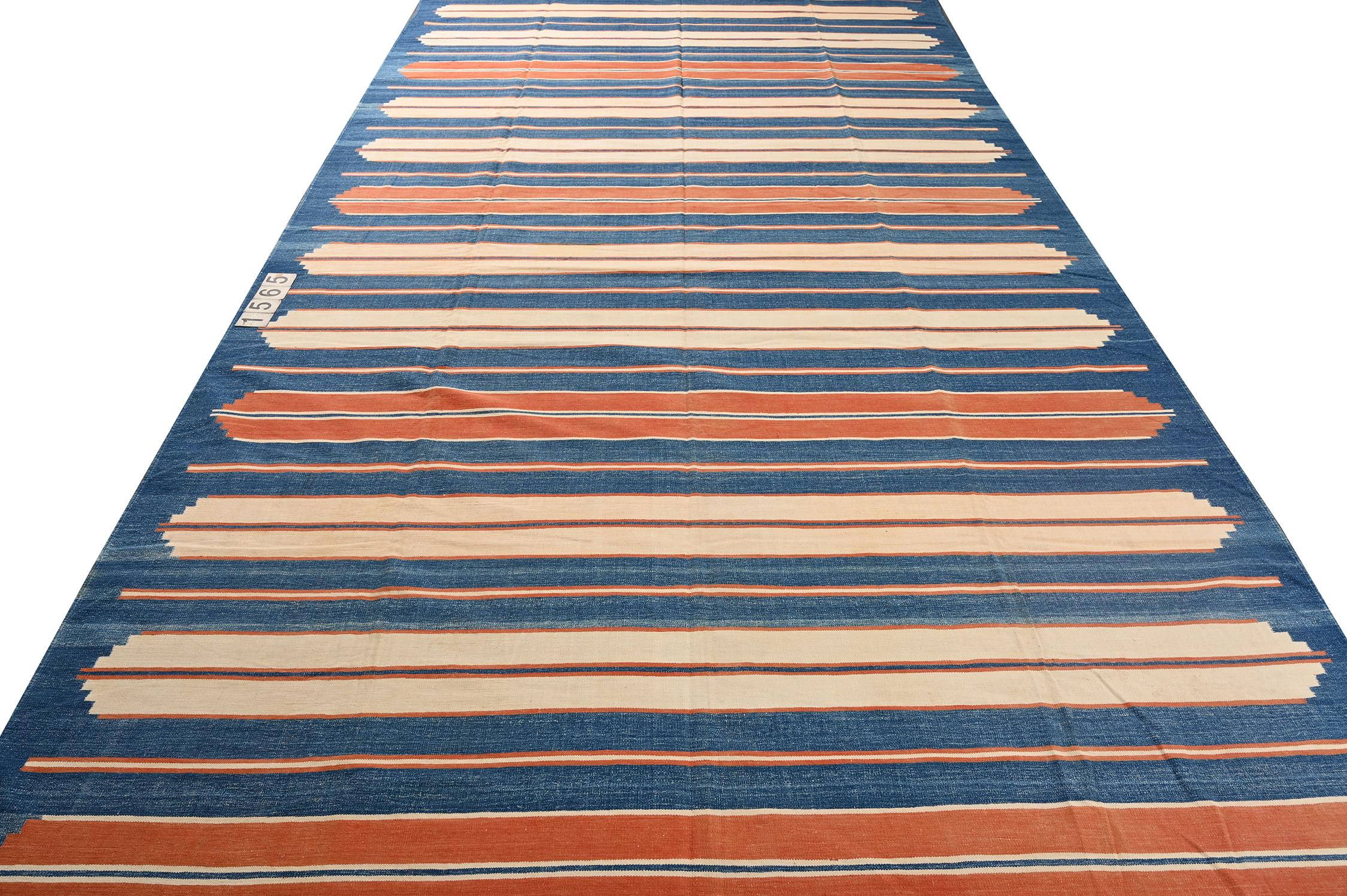 This vintage 9x15 Dhurrie is an exciting new entry in Rug & Kilim's esteemed flat weave collection. Handwoven in cotton, it originates from India circa 1950-1960. 

Further on the Design:

This flat weave unfurls in navy blue with orange and