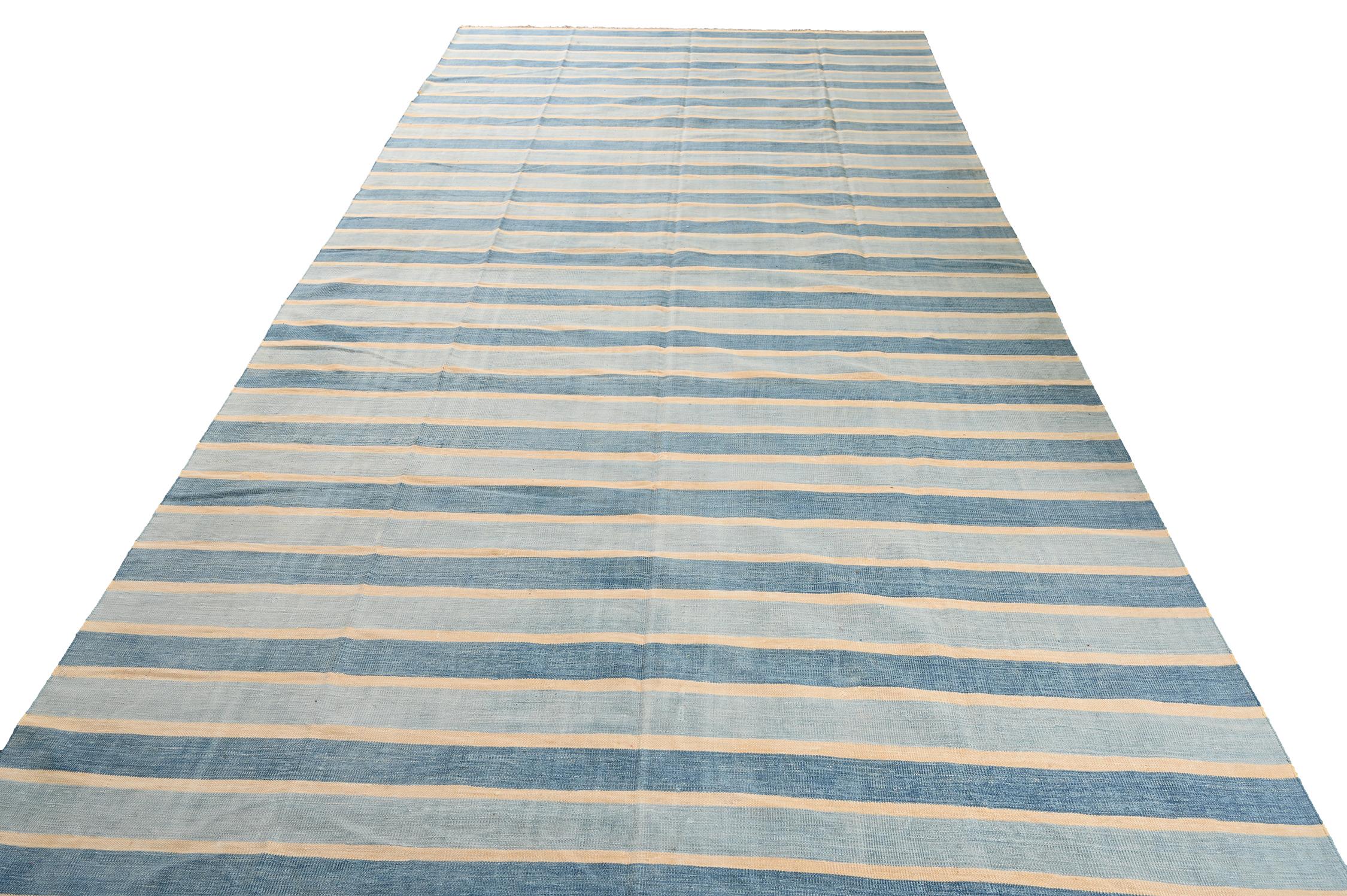 This vintage 7x14 Dhurrie is an exciting new entry in Rug & Kilim's esteemed flat weave collection. Handwoven in cotton, it originates from India circa 1950-1960. 

Further on the Design:

This flat weave prefers a simple series of stripes in