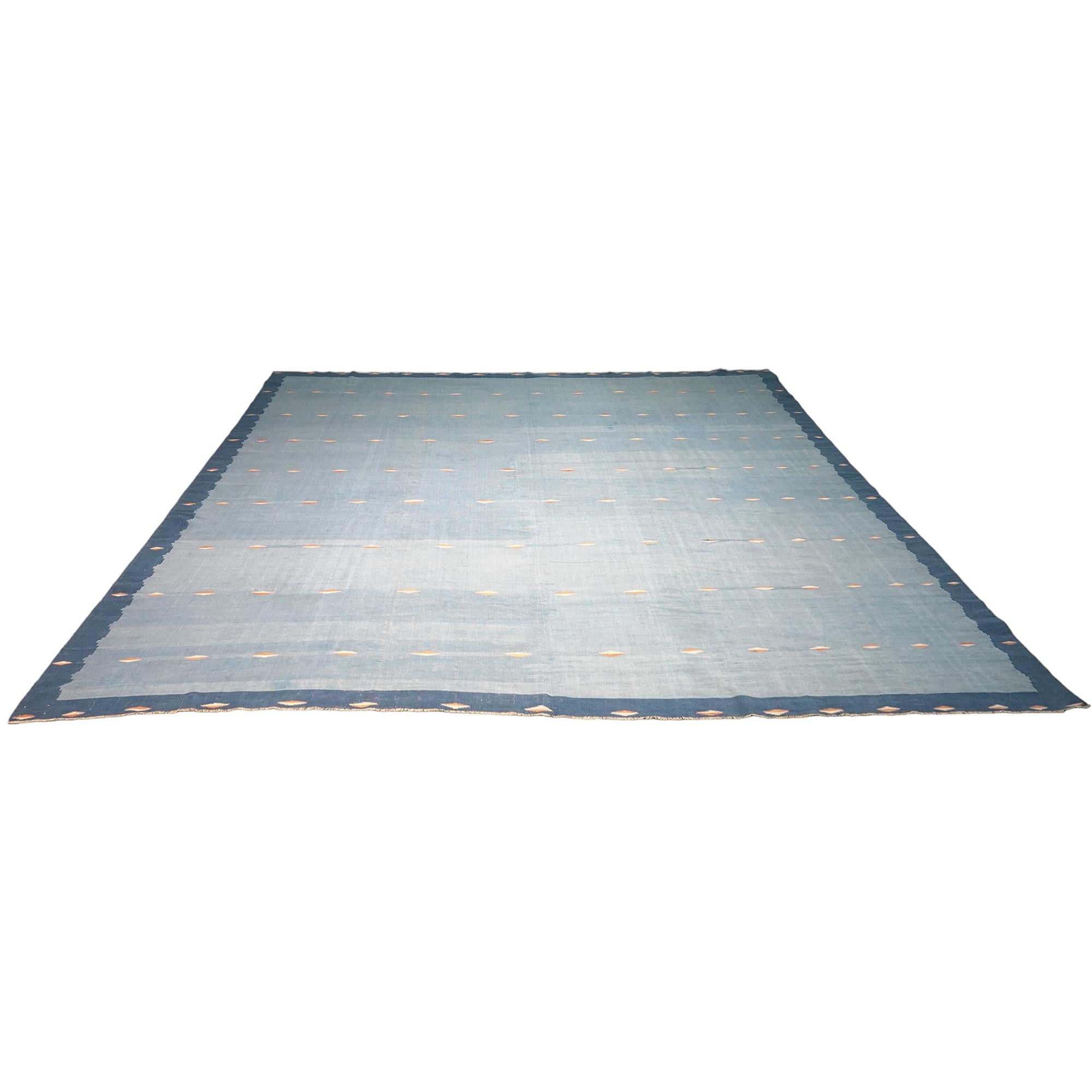 This vintage 10x10 Dhurrie flat weave is an exciting new entry in Rug & Kilim’s esteemed collection. Handwoven in wool, it originates from India circa 1950-1960. 

On the Design: 

From Rug & Kilim’s exclusive collection of vintage flatweaves, a