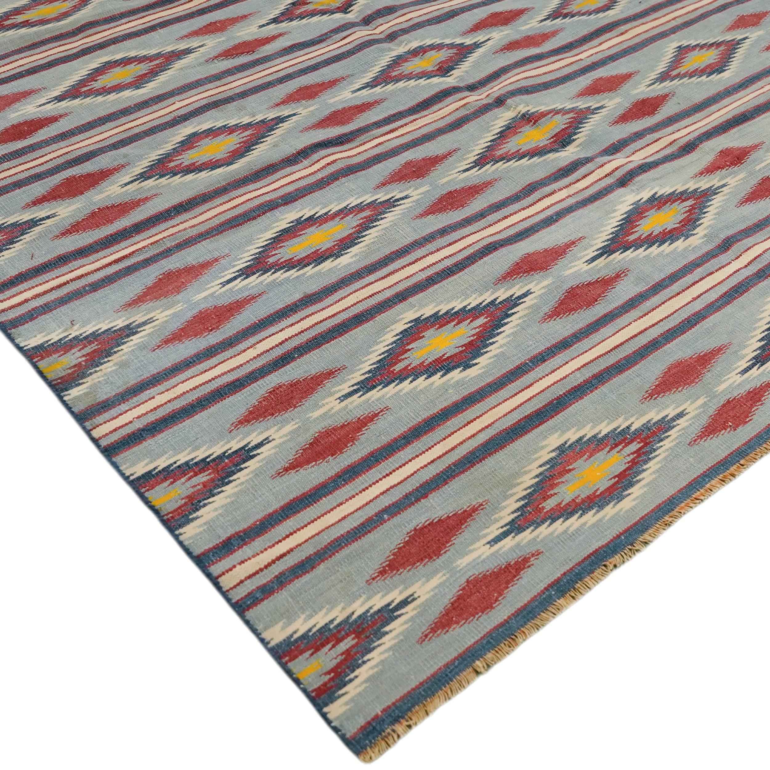 This 9x13 vintage Dhurrie rug is an exciting new curation from Rug & Kilim’s latest acquisition of rare and exemplary mid-century flatweaves of the same style. Handwoven in cotton, it originates from India circa 1950-1960. 

On the Design: 

This