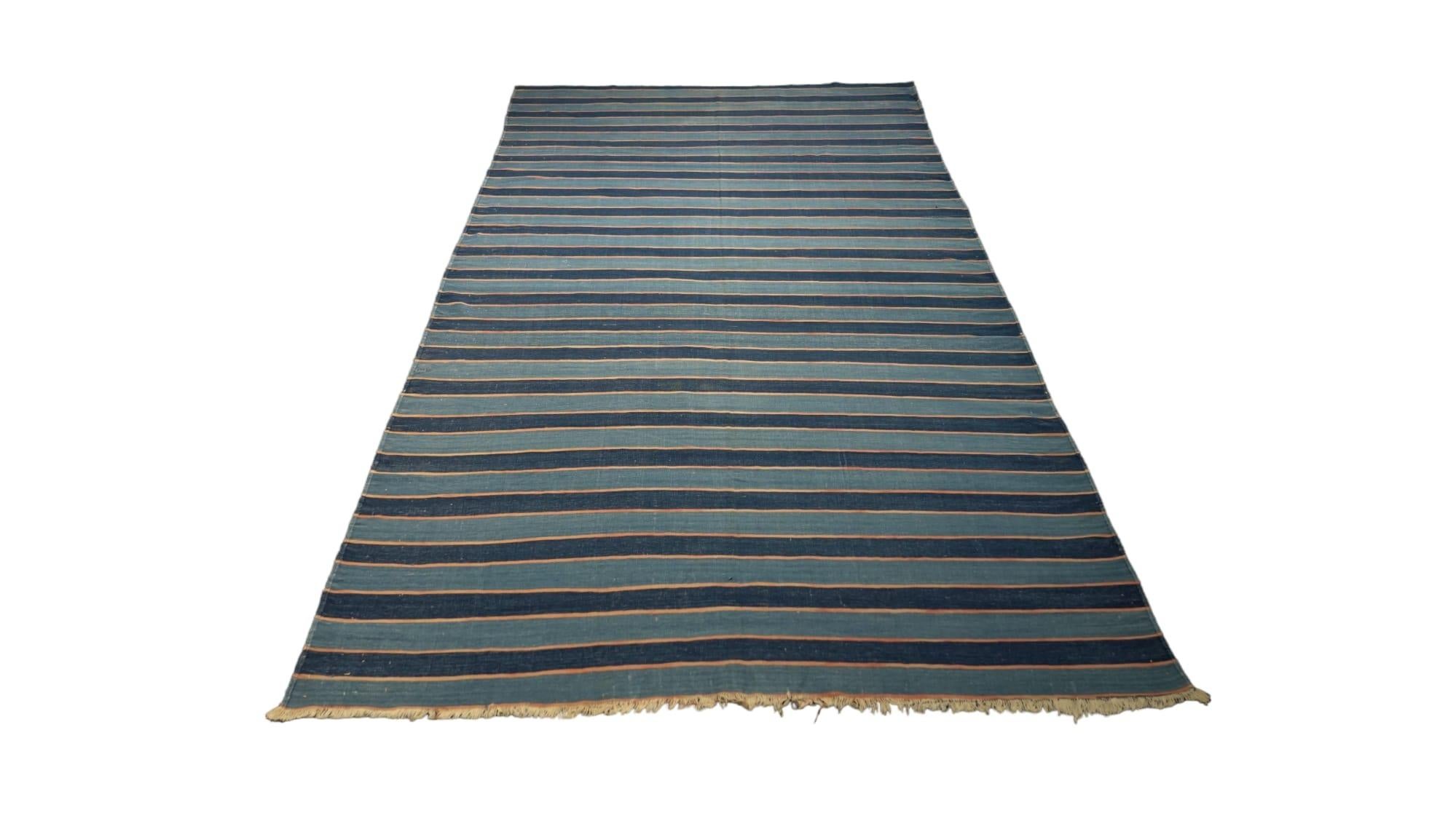 This vintage 5x9 Dhurrie flat weave is an exciting new entry in Rug & Kilim’s esteemed collection. Handwoven in wool, it originates from India circa 1950-1960. 

On the Design: 

From Rug & Kilim’s exclusive collection of vintage flatweaves, a
