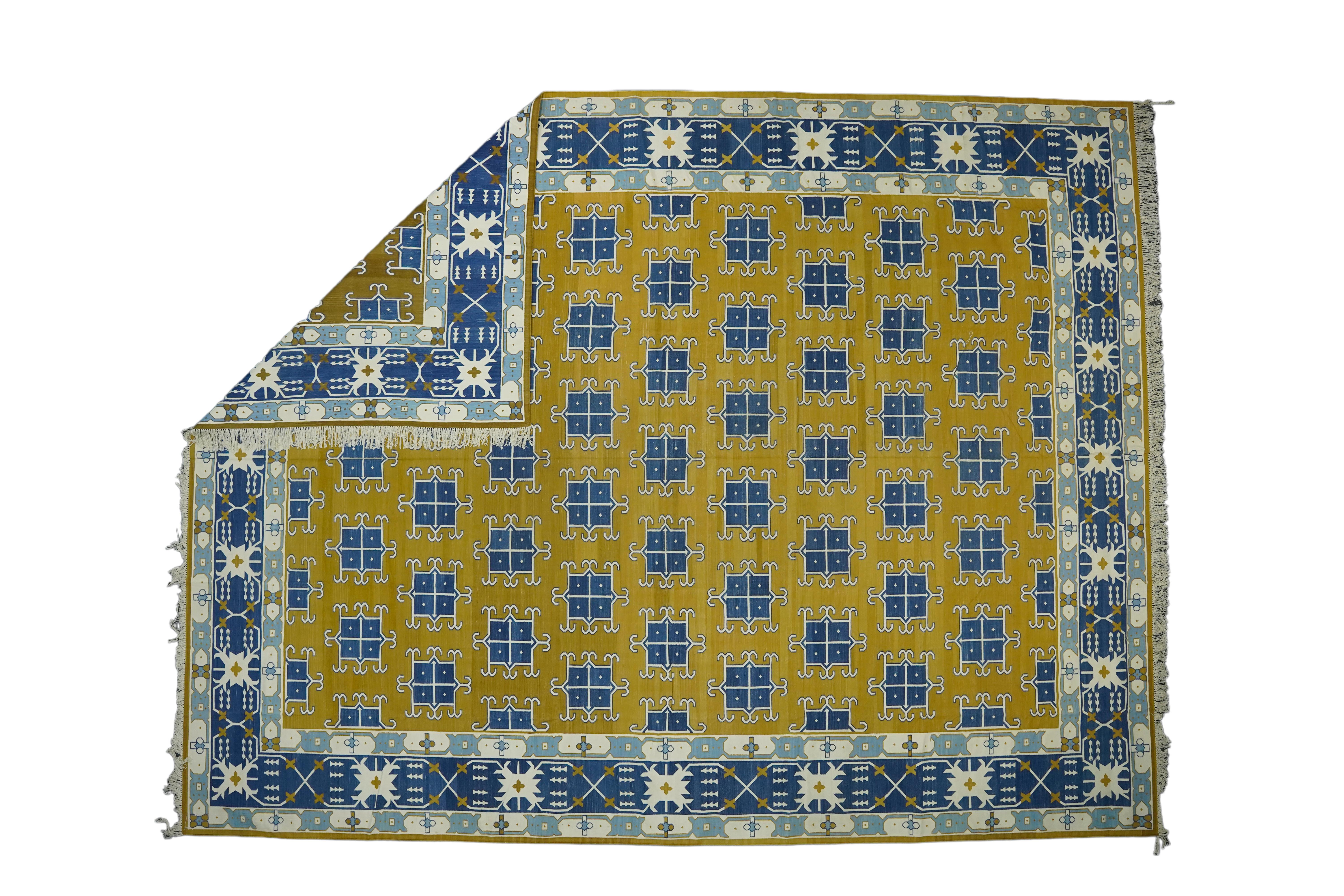This 12x16 rug is a rare vintage Dhurrie rug from an exciting new mid-century curation by Rug & Kilim. Handwoven in a wool flatweave, it originates from India circa 1950-1960, and enjoys a gold field with blue geometric patterns and white accents.