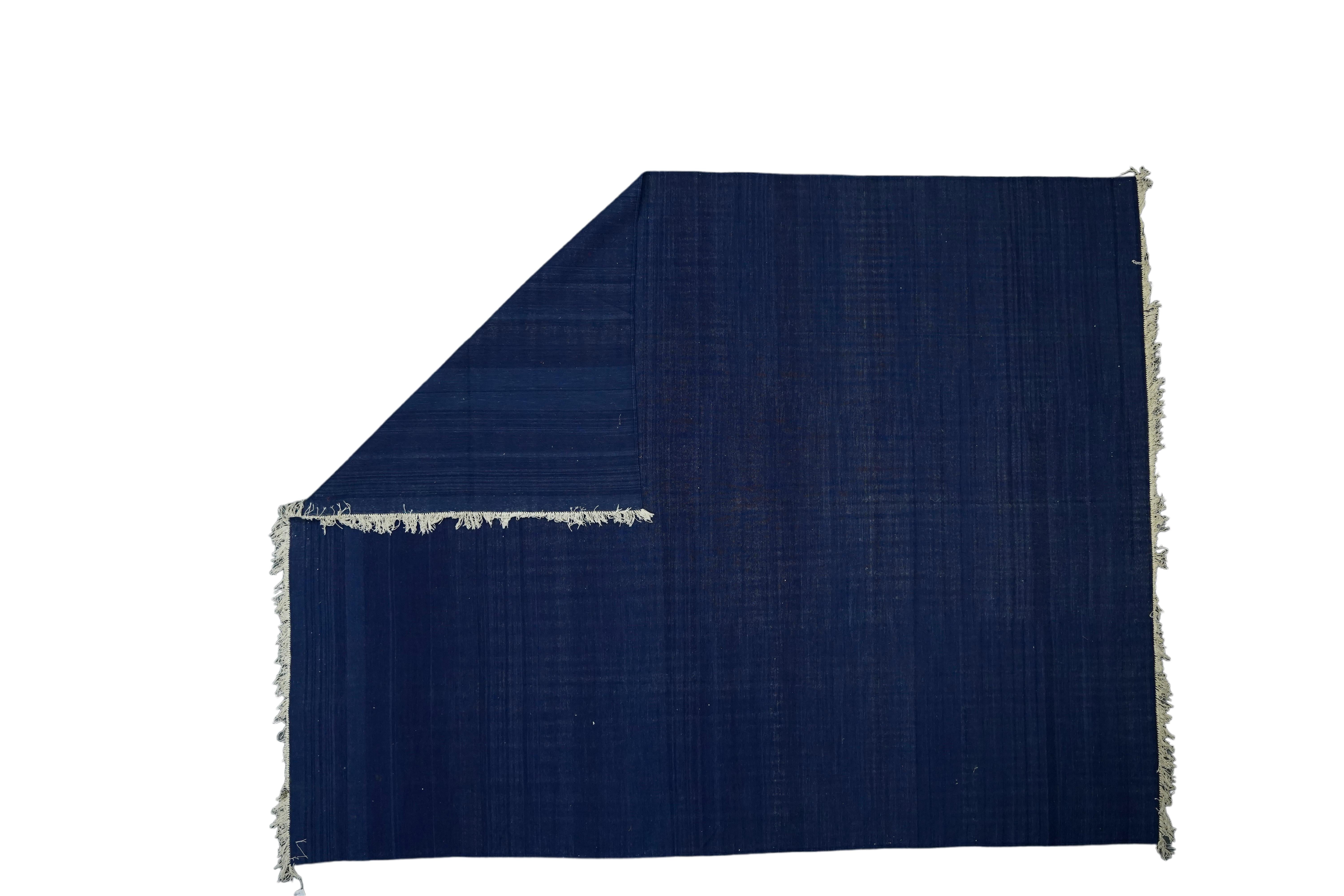 This 9x12 rug is a rare vintage Dhurrie rug from an exciting new mid-century curation by Rug & Kilim. Handwoven in a wool flatweave, it originates from India circa 1950-1960, and enjoys a deep saturated blue field with a natural abrash. 

On the