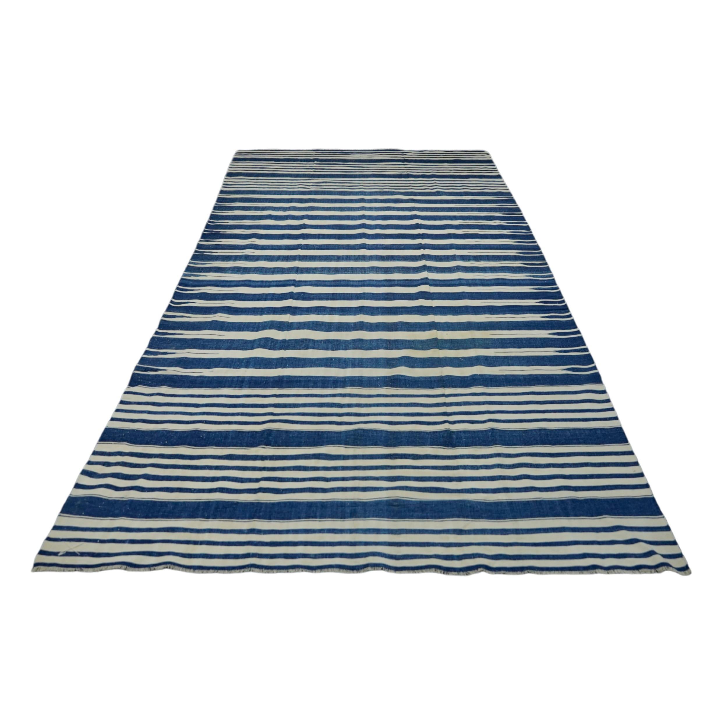 This 6x12 vintage Dhurrie rug is an exciting new curation from Rug & Kilim’s latest acquisition of rare and exemplary mid-century flatweaves of the same style—handwoven in cotton in India circa 1950-1960. 

On the Design: 

Admirers of the craft