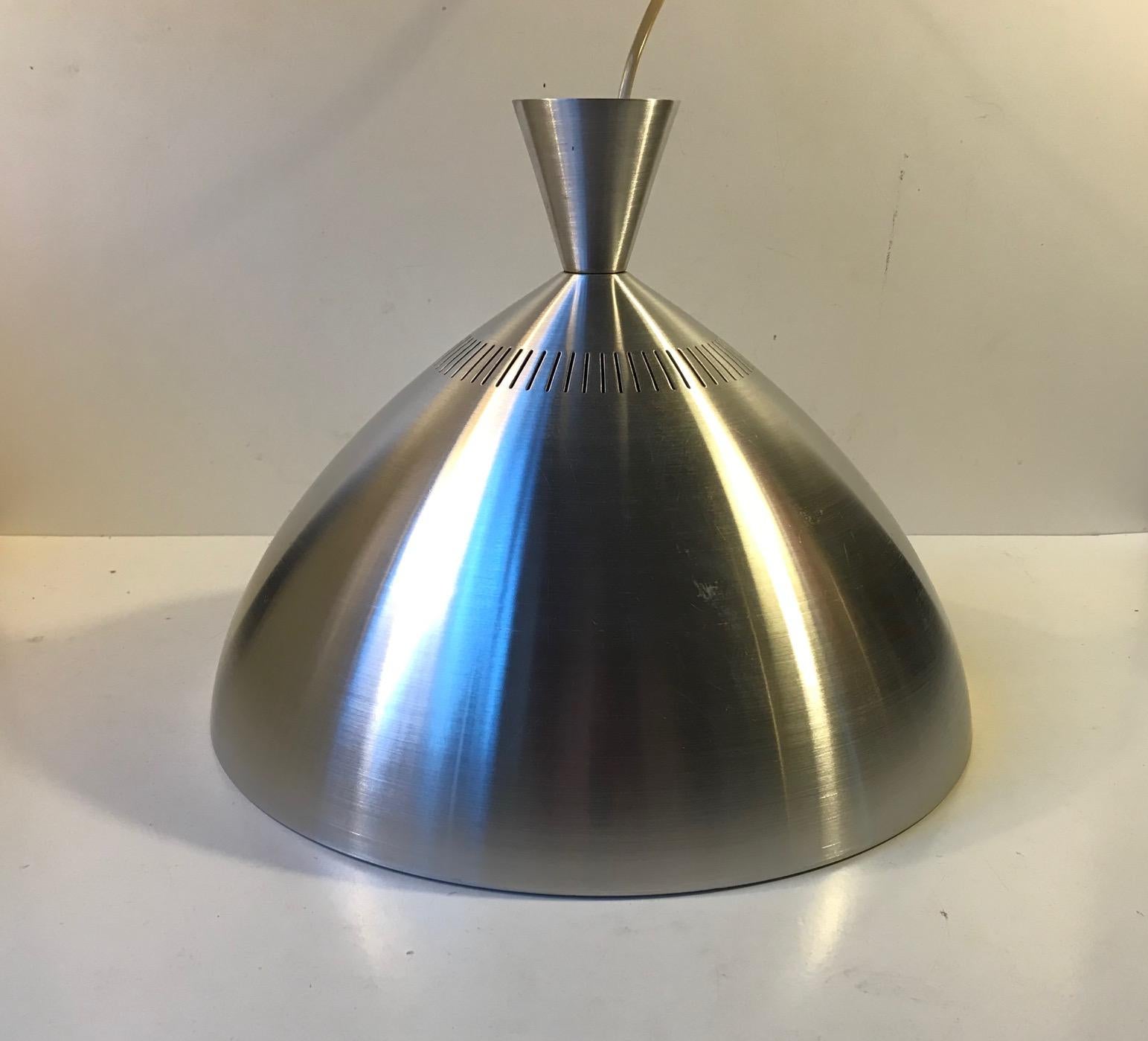 Scandinavian modern pendant light by Lyfa in Denmark. Designed and manufactured during the late 1960s in a style reminiscent of Jo Hammerborg Vega pendant lamp. It is made from partially perforated and brushed aluminium. The inside of the shade is