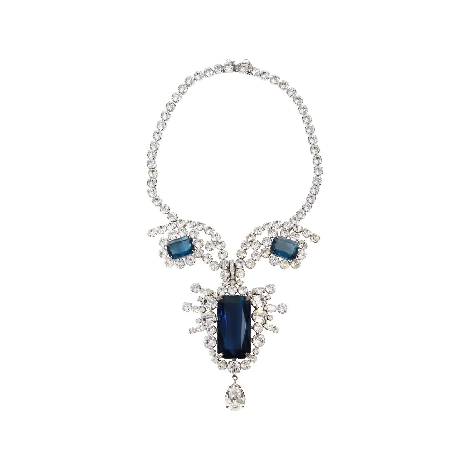Vintage Diamante and Sapphire Drop Necklace Circa 1980's.  This reminds me of something that princess Diana wore. There are small prong set round stones around the neck that  gather with two round sapphire stones which join to form a giant sapphire